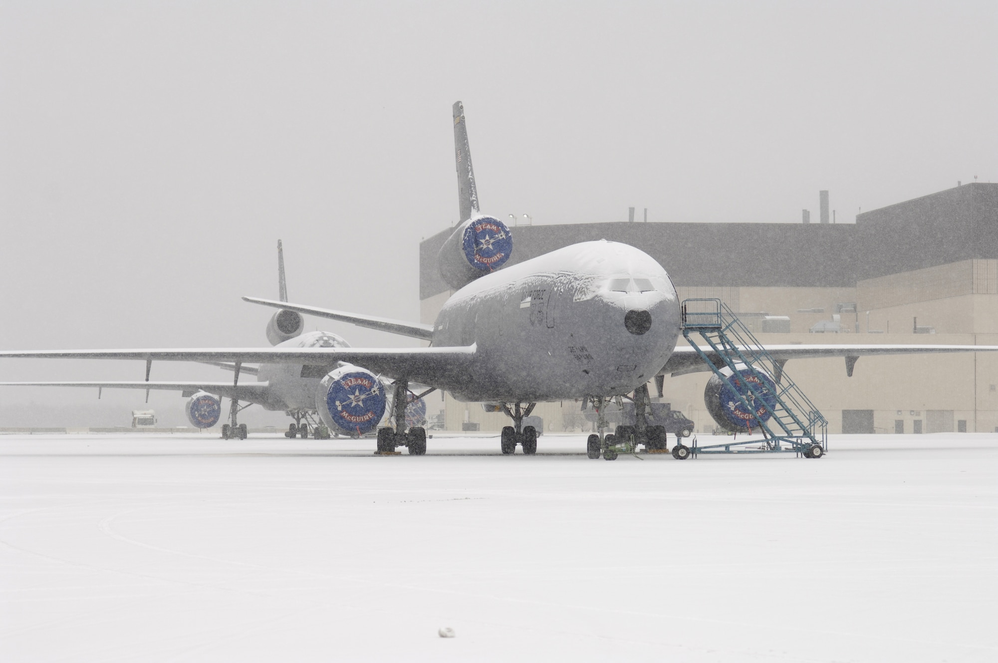 A row of KC-10A Extenders sit on the flight line March 7 at McGuire Air Force Base, N.J. awaiting to be deiced during a snowstorm that hit the base. (U.S. Air Force photo/Kenn Mann)