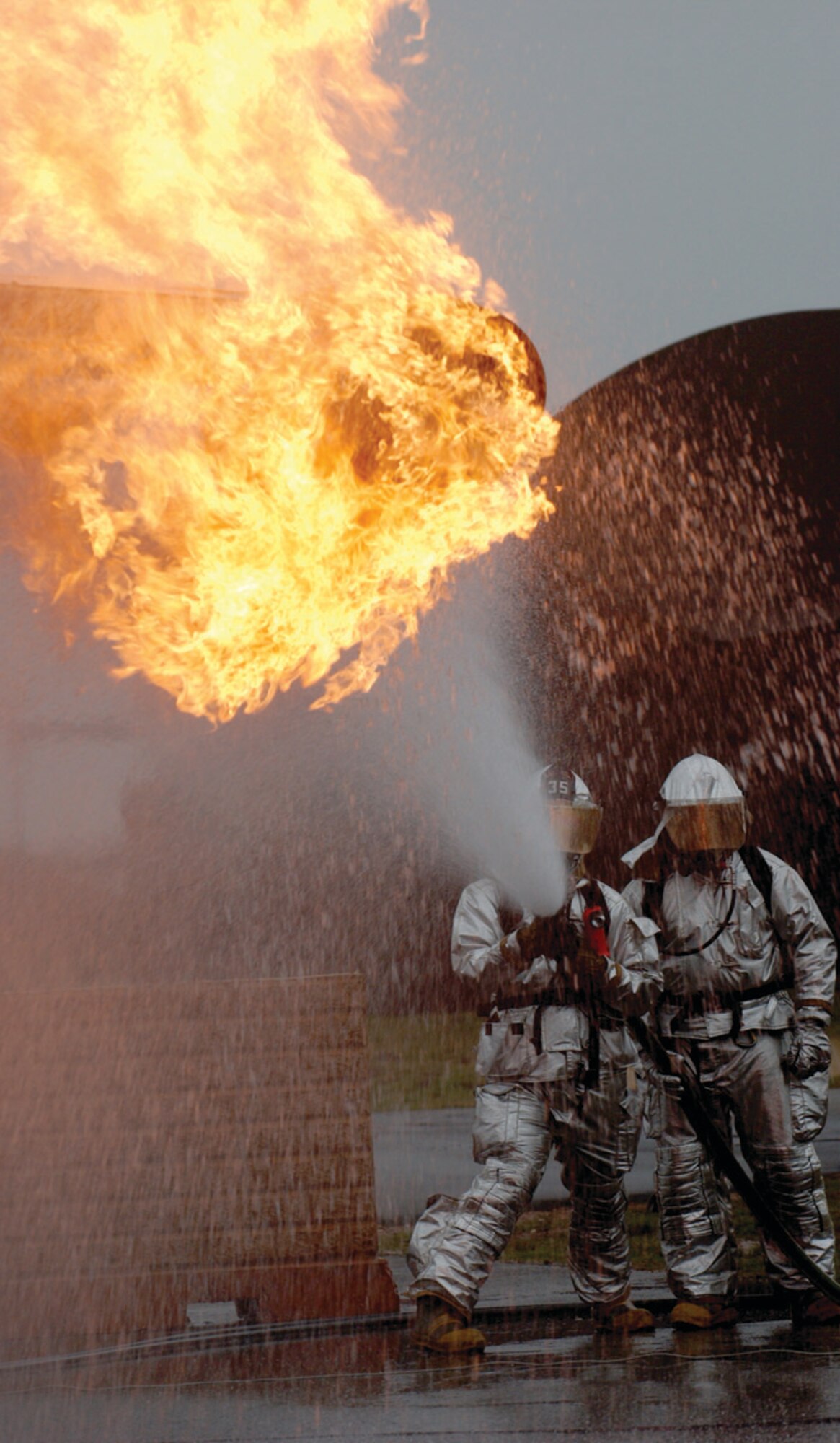 SPANGDAHLEM AIR BASE, GERMANY -- Two firefighters from the 52nd Civil Engineer Squadron participated in live-fire training at Ramstein Air Base March 1. Training on the Mobile Aircraft Fire Trainer is an annual requirement for all firefighters. (US Air Force photo/Senior Airman Josie Kemp)