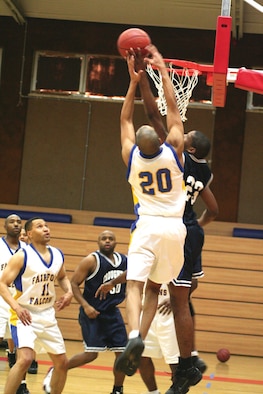 SPANGDAHLEM AIR BASE, GERMANY -- AJ Harold, number 20 from Royal Air Force Fairford, battles for a rebound with Frank Macdonald, number 23 from Royal Air Force Croughton during the 2007 U.S. Air Forces in Europe Small Unit Championship at Spangdahlem Air Base. Croughton won the championship with a dominating 92-51 victory. (US Air Force photo/Ed Marshall)