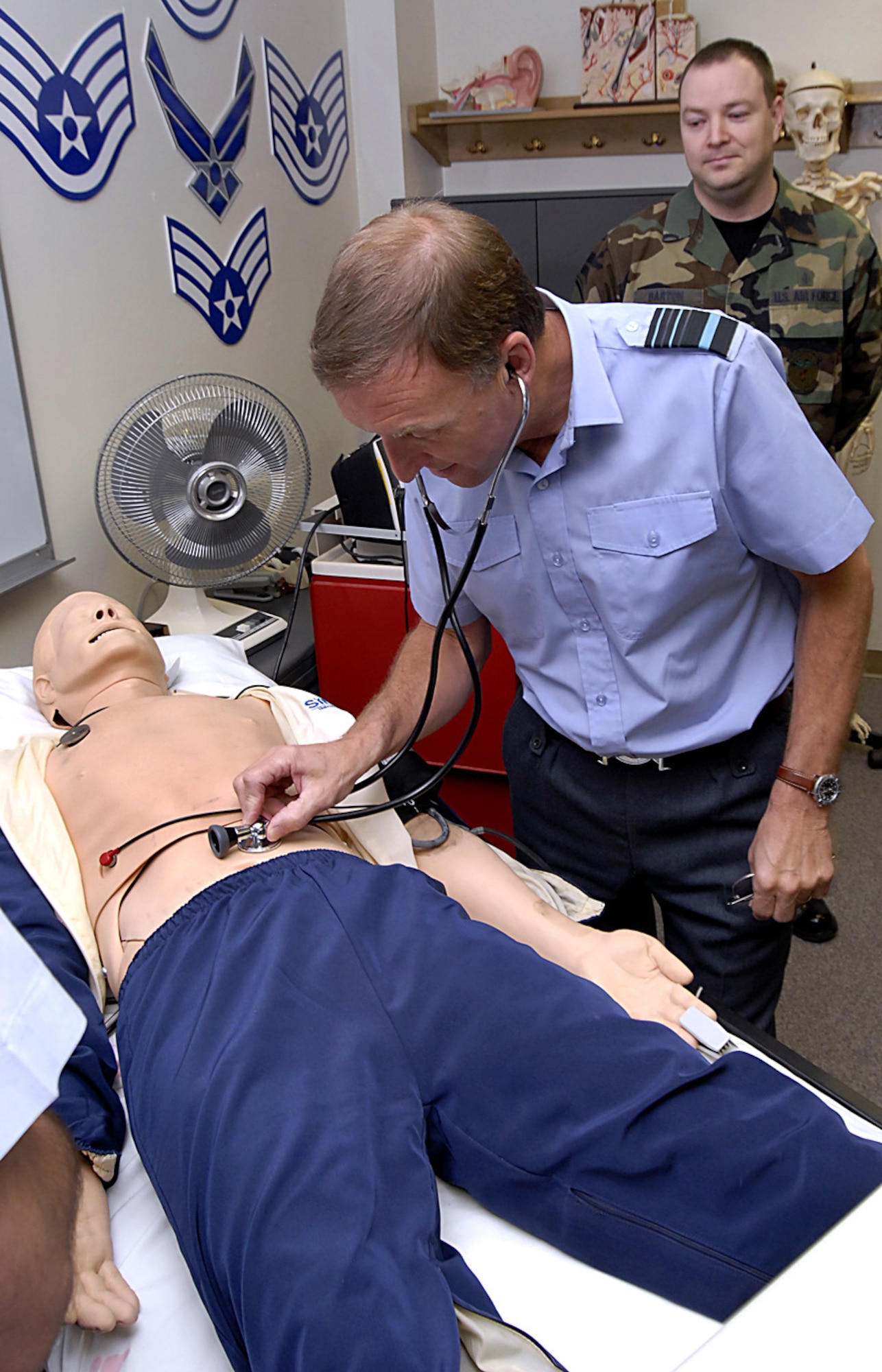 British Royal Air Force Air Marshal Barry Thornton, Commander in Chief of Personnel and Training Command, checks the vitals on a "patient" during his visit March 6 at Sheppard Air Force Base, Texas. Air Marshal Thornton spent the day at Sheppard visiting training locations across base. (U.S. Air Force photo/Harry Tonemah)