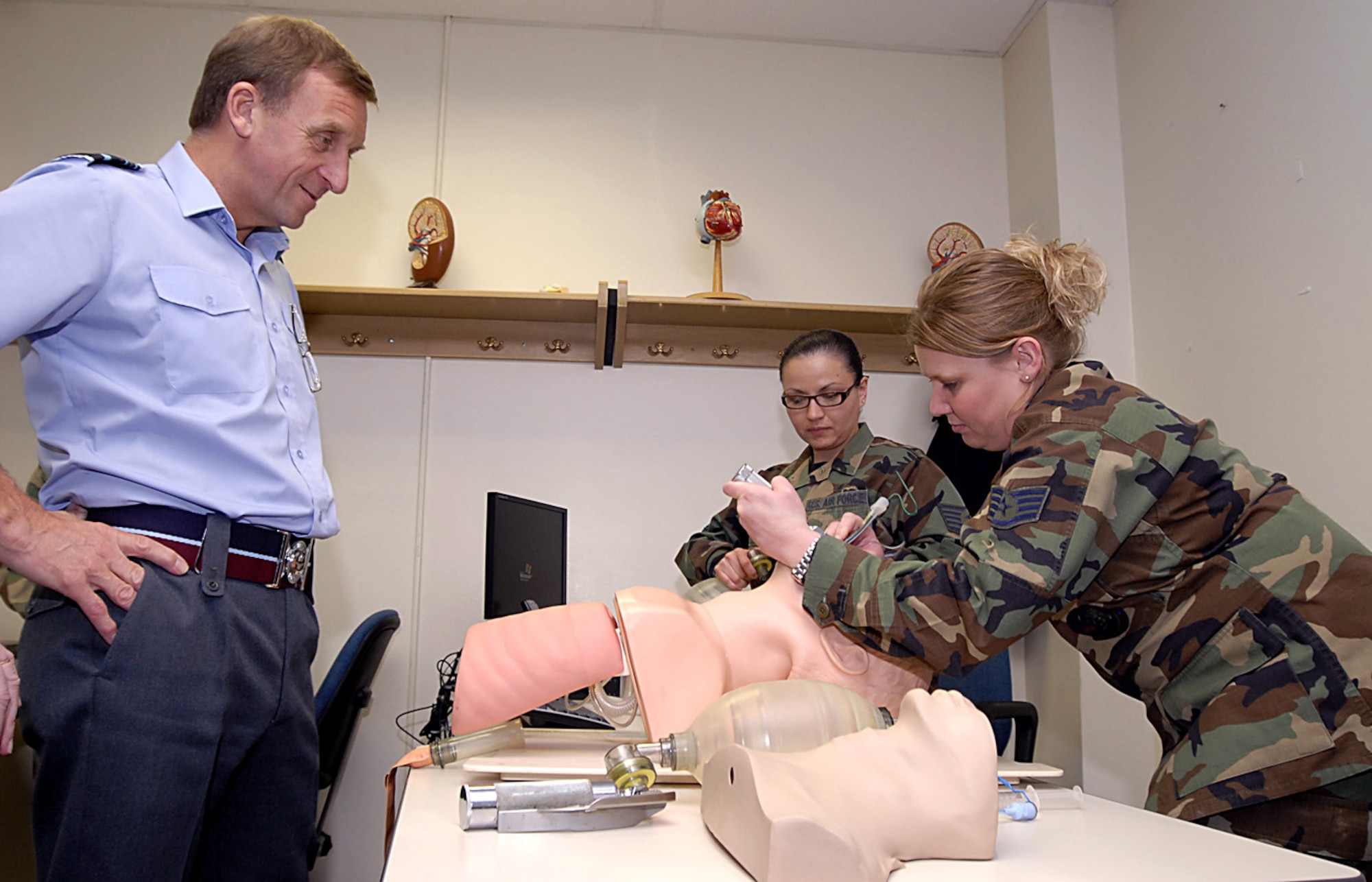 British Royal Air Force Air Marshal Barry Thornton, Commander in Chief of Personnel and Training Command watches as an IDMT Airmen-in-Training intubates a "patient" March 6 during the air marshal's visit. Air Marshal Thornton spent the day at Sheppard visiting training locations across base. (U.S. Air Force photo/Harry Tonemah)