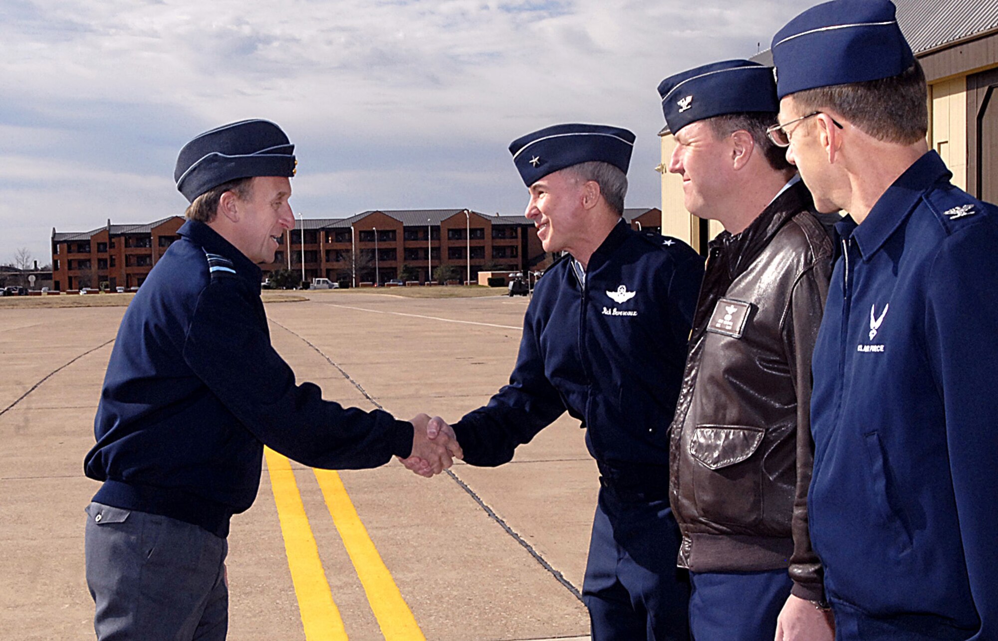 Brig. Gen. Richard Devereaux, 82nd Training Wing commander, greets British Royal Air Force Air Marshal Barry Thornton, Commander in Chief of Personnel and Training Command upon his arrival at Sheppard Air Force Base, Texas, March 6. The air marshal was also greeted by Col. Jeffery Kendall, 80th Flying Training Wing Commander, and Col. Lansen Conley, 82nd TRW vice commander. Air Marshal Thornton spent the day at Sheppard visiting training locations across base. (U.S. Air Force photo/Harry Tonemah)