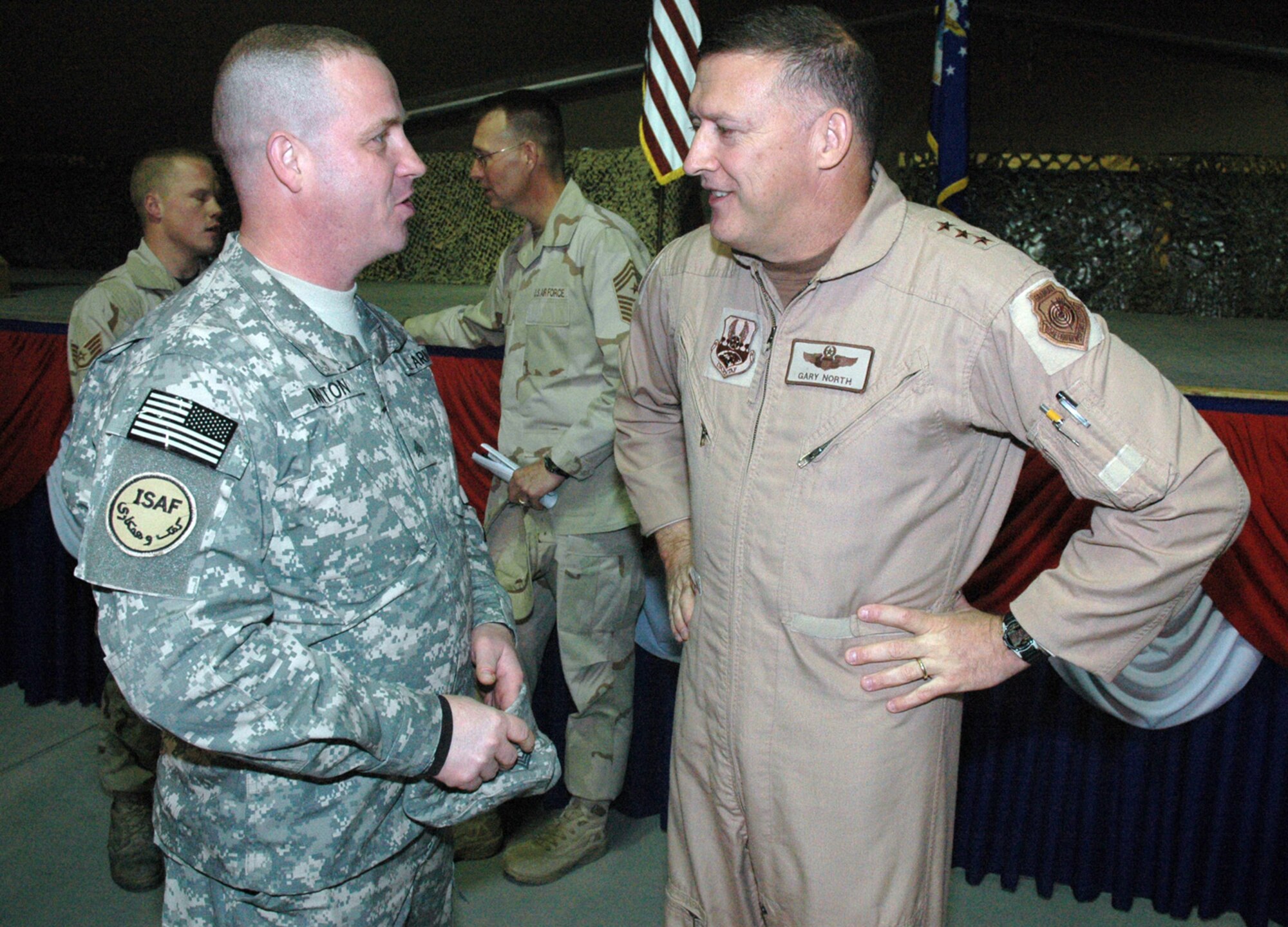 Lt. Gen. Gary North talks air power integration and his contract with ground forces with Army Staff Sgt. Jon Minton, 376th Expeditionary Logistics Readiness Squadron Liaison Officer, at Manas Air Base, Kyrgyzstan. (U.S. Air Force photo/Master Sgt. Daniel Nathaniel) 