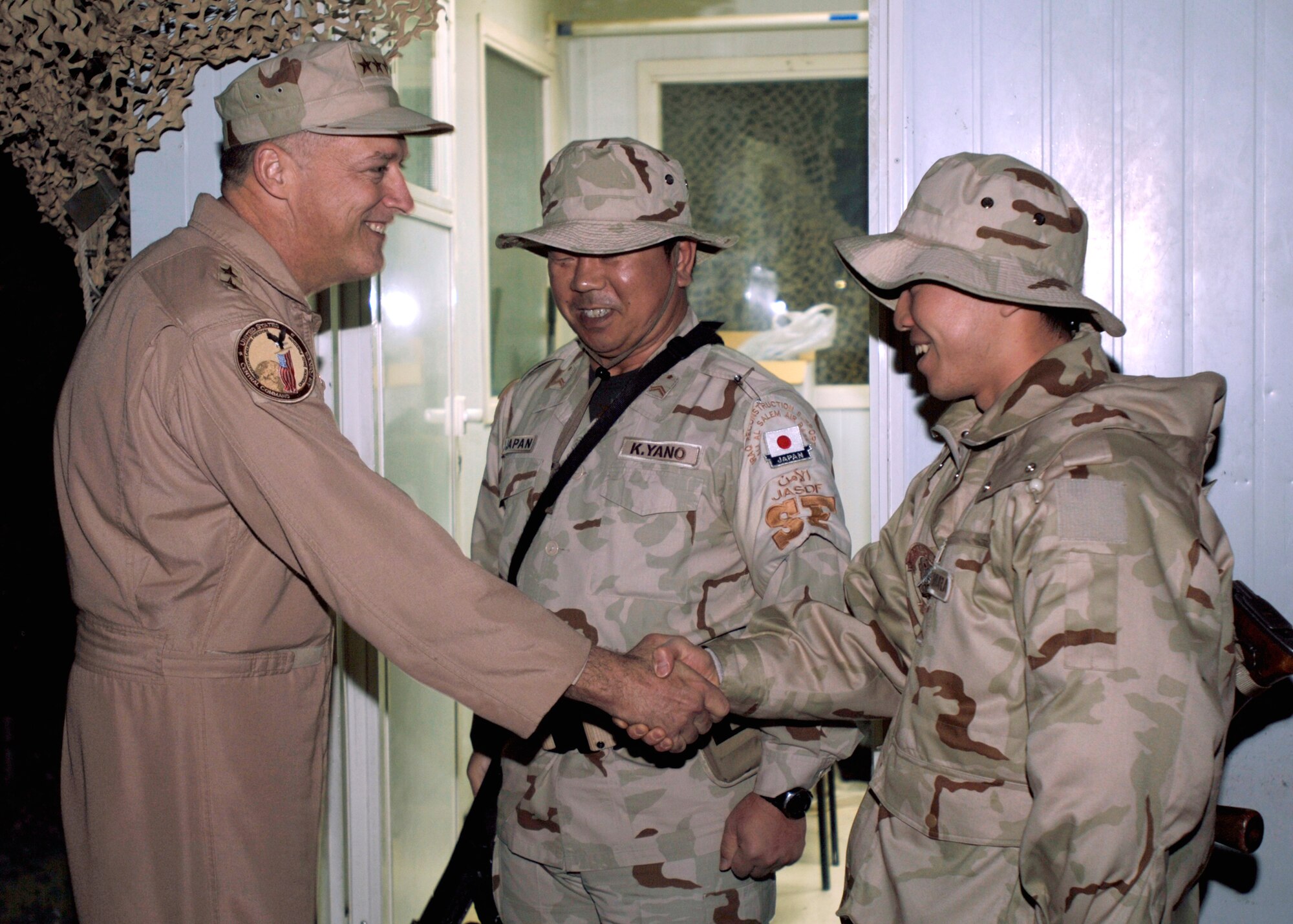 SOUTHWEST ASIA -- Lt. Gen. Gary L. North, Commander, 9th Air Force and U.S. Central Command Air Forces introduces himself to K. Yano and M. Ishimura, members of the Japan Air Self Defense Force (JASDF) at an undisclosed location in Southwest Asia last Saturday night.  USAF Photo by TSgt Edward D. Holzapfel (RELEASED)