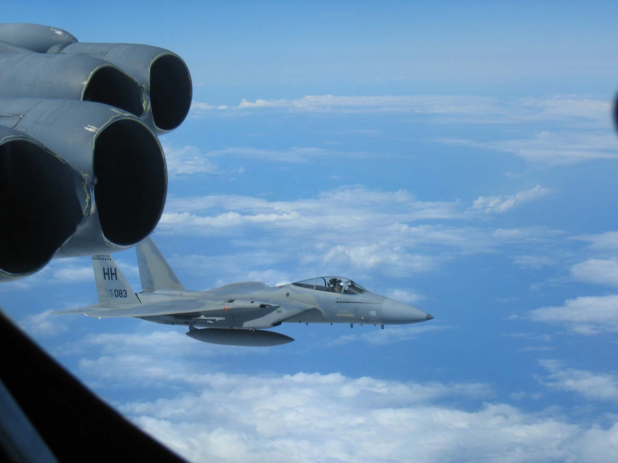 A Hickam-based F-15 flies alongside a B-52 Stratofortress deployed from Andersen Air Force Base, Guam, during the recent Koa Lightning exercise held in the Pacific Theatre.  Airmen from the 96th Expeditionary Bomb Squadron flew 18-hour missions in their B-52s allowing the aircrews to hone their skills in close air support and dissimilar aircraft combat training.  (U.S. Air Force Photo by Maj. Eric Sikes)