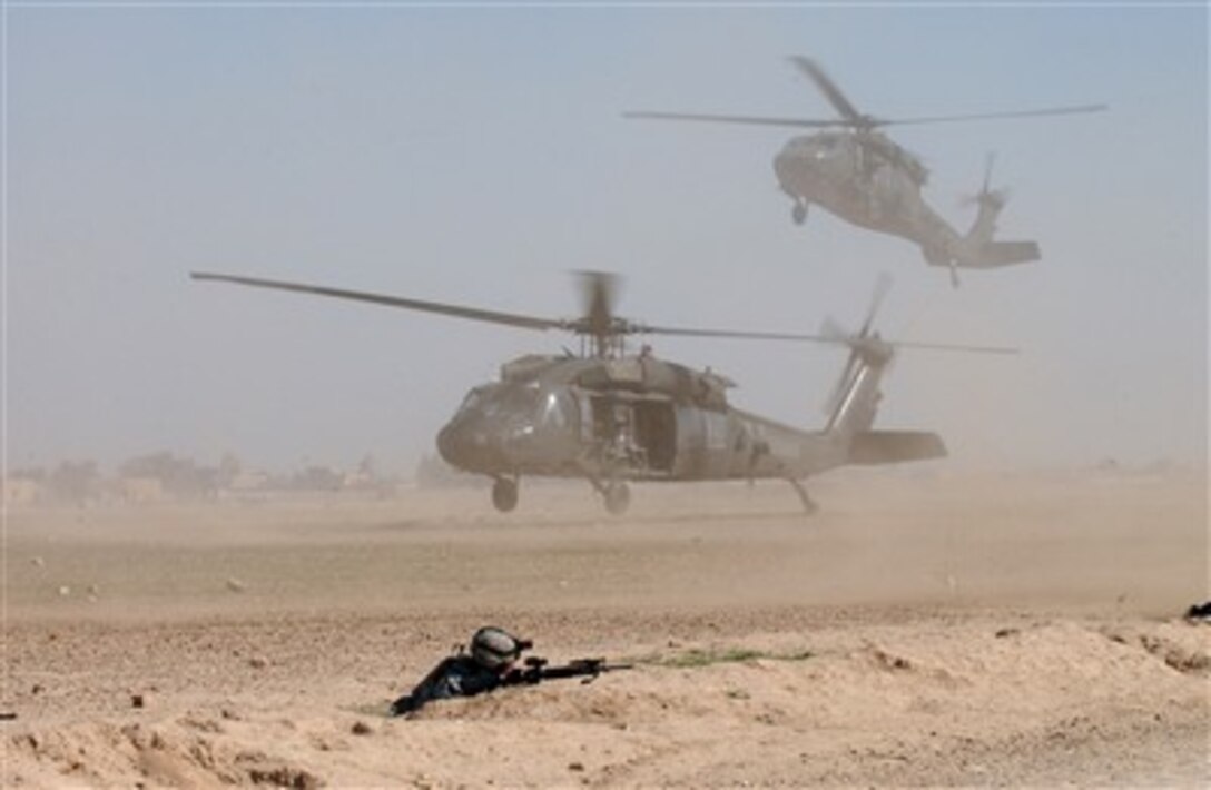 Two U.S. Army UH-60 Black Hawk helicopters blow up clouds a of dust as they come into a landing zone in Samarra, Iraq, to pick up U.S. Army soldiers on March 3, 2007.  The soldiers are from Delta Company, 3rd Battalion, 8th Cavalry Regiment, 1st Cavalry Division.  