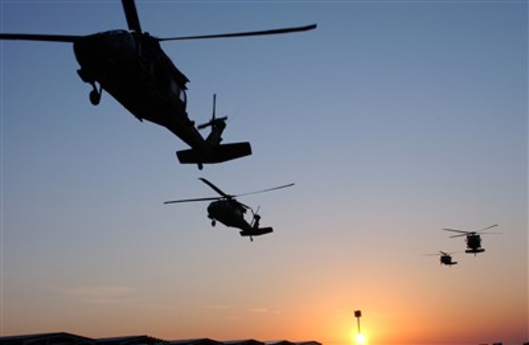 U.S. Army UH-60 Black Hawk helicopters prepare to pick up and transport soldiers for an air assault mission near Samarra, Iraq, March 3, 2007.
