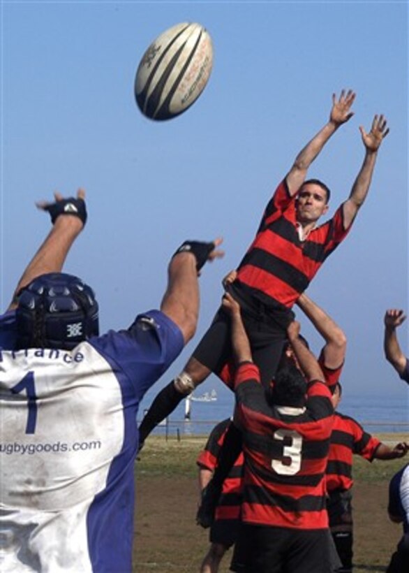 U.S. Marine Corps Capt. Edward Carpenter, a U.S. Navy Japan team rugby player, leaps to block a "throw in" by all-France team player Macthieu Rosenburge during a rugby game at Berkley Field in Yokosuka, Japan, on March 4, 2007. 