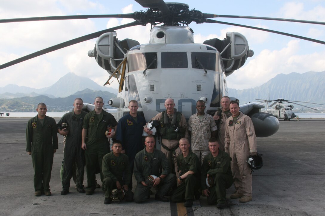 Lieutenant General John G. Castellaw (top row center) poses in fornt of "Ugly 50" with members of Marine Heavy Helicopter Squadron 362 aboard Marine Corps Base Hawaii, Kaneohe Bay, March 8.