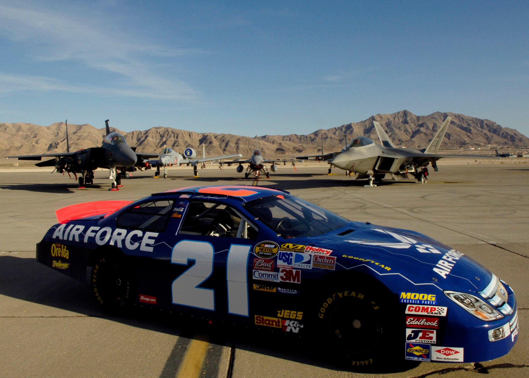 The Air Force No. 21 car is displayed on the flight line at Nellis Air Force Base, Nev., March 8. Wood is at Nellis visiting Airmen before his NASCAR Nextel Cup UAW Daimler-Chrysler 400 race March 10. (U.S. Air Force Photo/Master Sgt. Robert W. Valenca)
