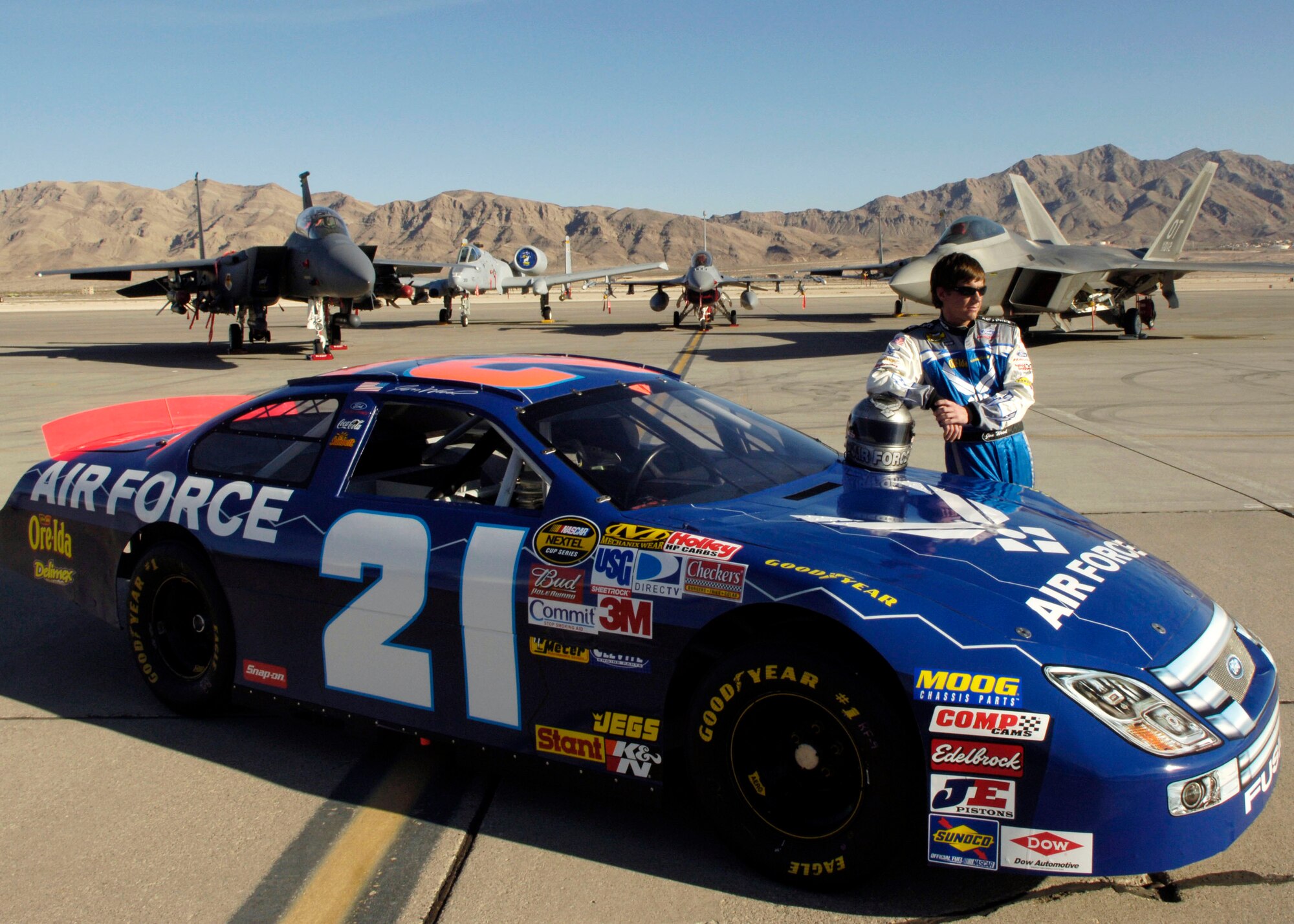 Jon Wood, driver of the Air Force car, poses for photos on the flightline at Nellis Air Force Base, Nev., March 8.  Wood is at Nellis visiting Airmen before his NASCAR Nextel Cup UAW Daimler-Chrysler 400 race March 10. (U.S. Air Force Photo/Master Sgt. Robert W. Valenca)