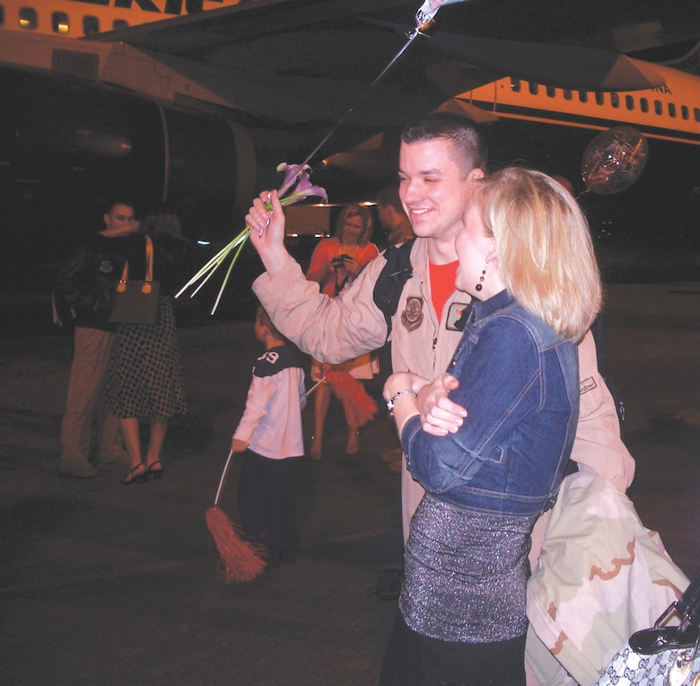 MCCHORD AIR FORCE BASE, Wash. -- Capt. Mark Jones, 4th Airlift Squadron, shares a laugh with his wife, Lori, March 3 after returning from a 120-day deployment in support of the Global War on Terror. More than 100 Airmen from the 4th AS were greeted by family and friends upon their arrival back at McChord.