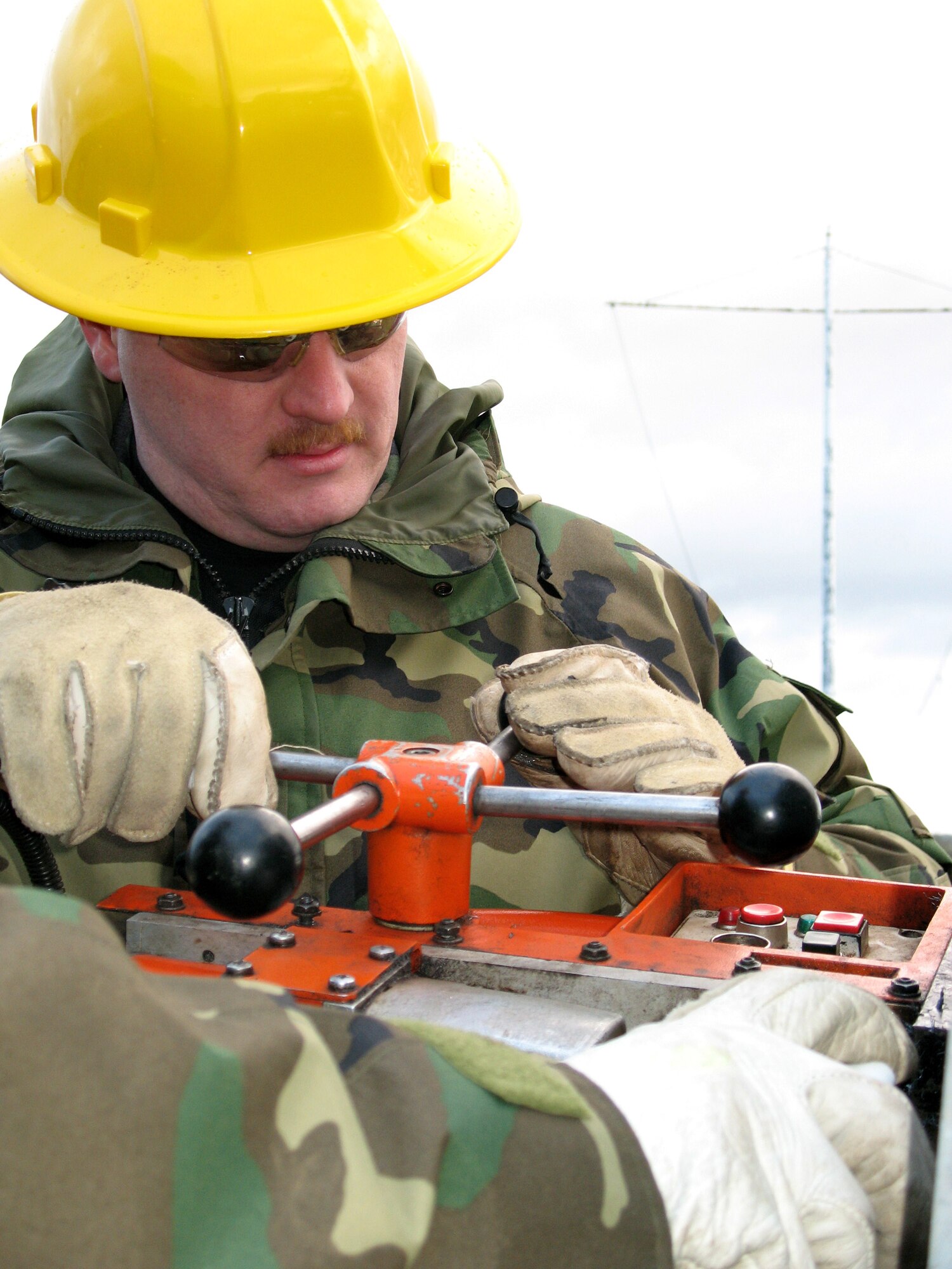 Airfield systems technician Tech. Sgt. Jerry McDonald drills a hole to fit the new speaker stack for the giant voice upgrade March 7 at Royal Air Force Barford St. John, England. Sergeant McDonald along with eight other Airmen from the 1st Communications Maintenance Squadron at Kapaun Air Station, Germany, are upgrading the giant voice system in nine different locations throughout the United Kingdom. (U.S. Air Force photo/Tech. Sgt. Greg Bluethmann) 