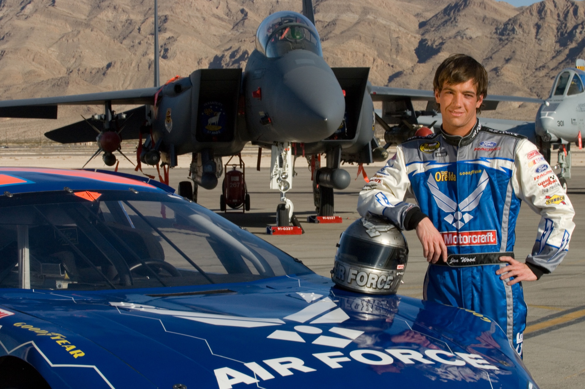 Jon Wood, driver of the Air Force car, poses for photos on the flightline at Nellis Air Force Base, Nev., March 8.  Jon was at Nellis visiting Airmen before his NASCAR Nextel Cup UAW Daimler-Chrysler 400 on Sunday, March 10. (U.S. Air Force Photo by Master Sgt Robert W. Valenca)    

