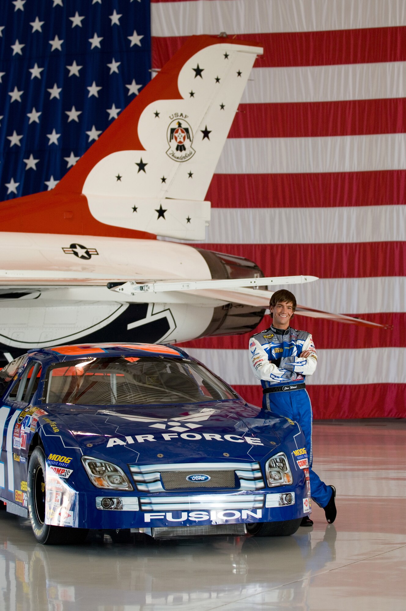 Jon Wood, driver of the Air Force car, poses in the Thunderbird hangar at Nellis Air Force Base, Nev., March 8.  Jon was at Nellis visiting Airmen before his NASCAR Nextel Cup UAW Daimler-Chrysler 400 on Sunday, March 10. (U.S. Air Force Photo by Master Sgt Robert W. Valenca)    

