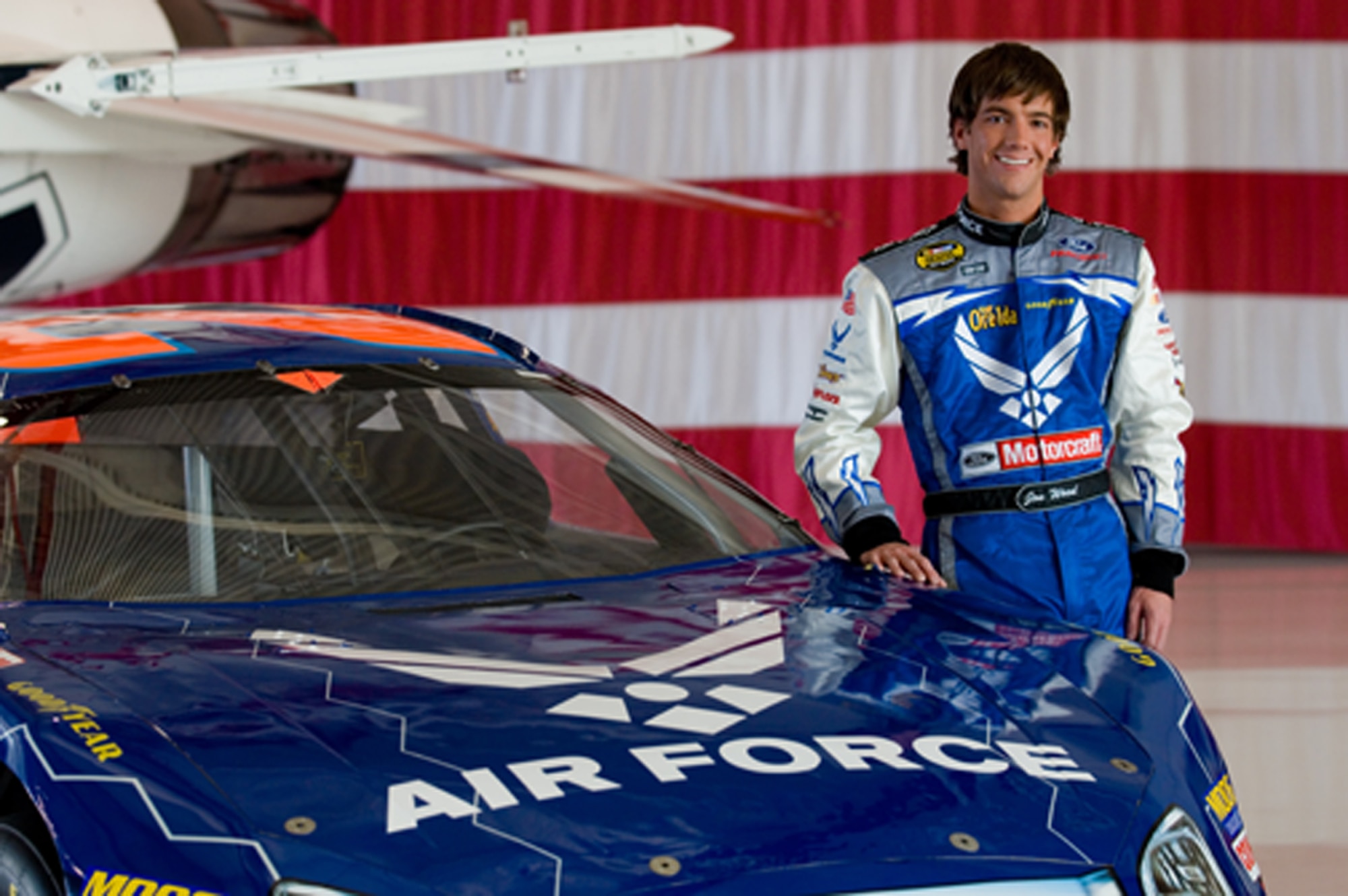 Jon Wood, driver of the Air Force car, poses in the Thunderbird hangar at Nellis Air Force Base, Nev., March 8.  Jon was at Nellis visiting Airmen before his NASCAR Nextel Cup UAW Daimler-Chrysler 400 on Sunday, March 10. (U.S. Air Force Photo by Master Sgt Robert W. Valenca)    

