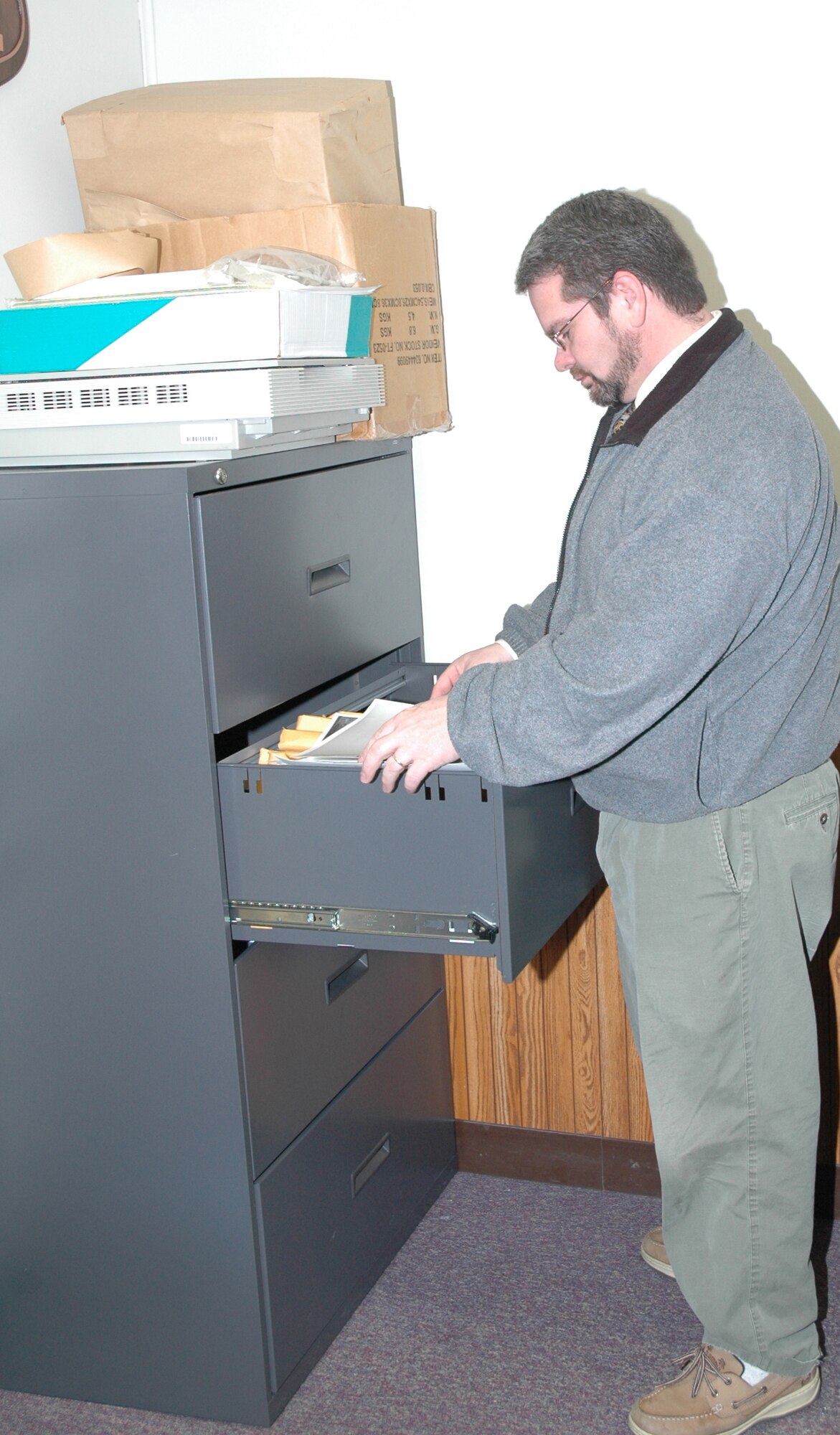 Andrew Billman looks through some archived photographs to fill a customer's request. He was recently hired as the 341st Space Wing historian.