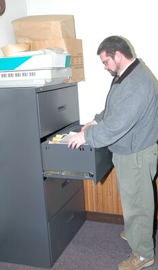 Andrew Billman looks through some archived photographs to fill a customer's request. He was recently hired as the 341st Space Wing historian.