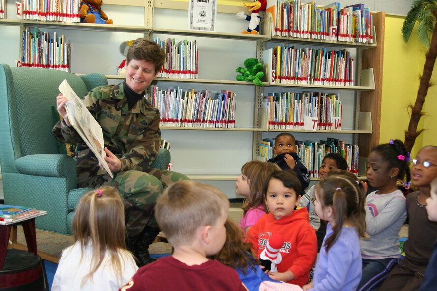 EGLIN AIR FORCE BASE, Fla. -- Col. Theresa Giorlando, 96th Mission Support group, reads one of four books to a group from the Child Development Center to kick off Women's History Month at the base library March 6. Colonel Giorlando spoke to a group of 43 preschoolers, parents and caregivers about "the things that little girls can grow up to be." (U.S. Air Force photo by Dorothee Bennett)