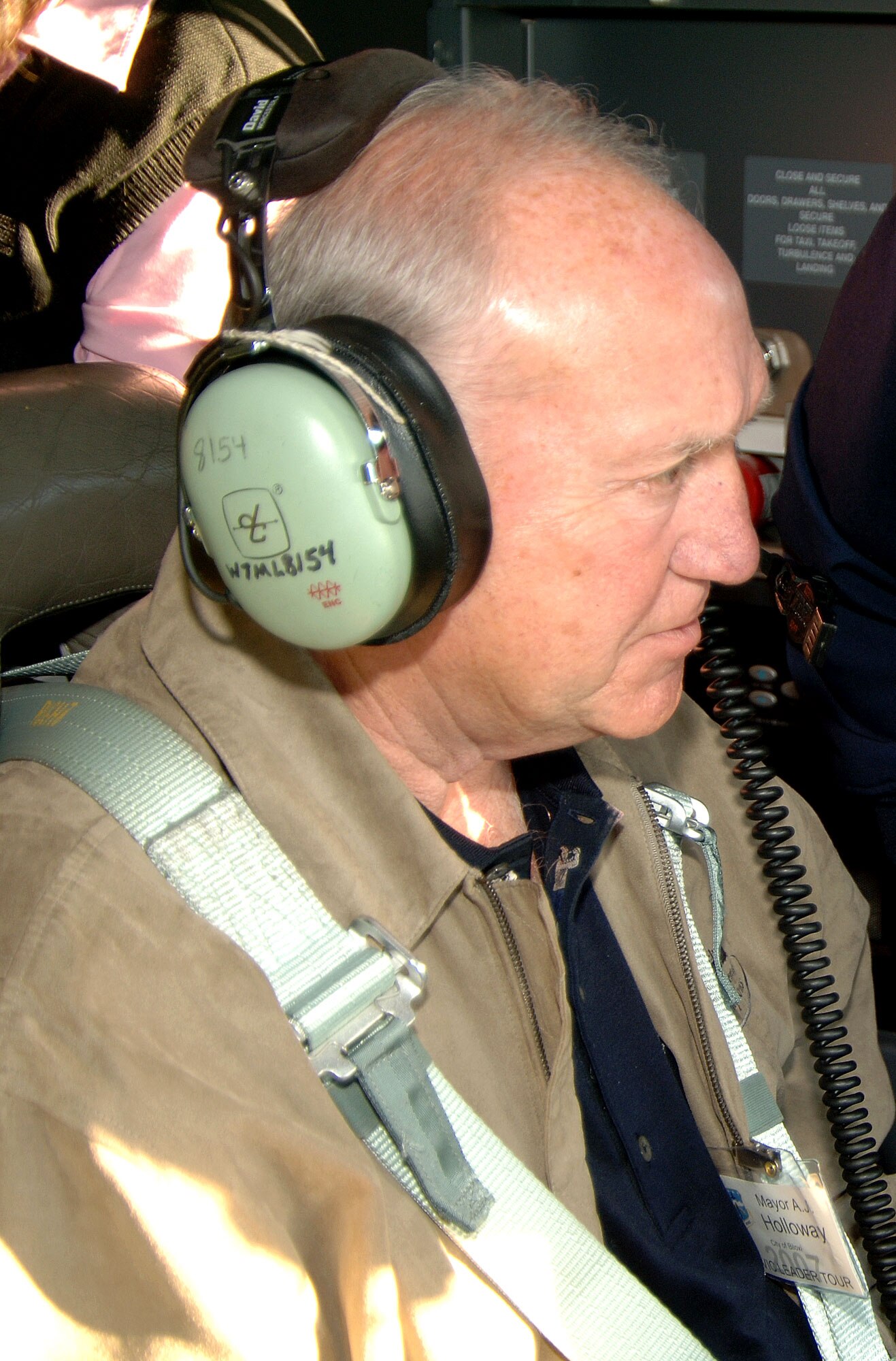 KEESLER AIR FORCE BASE, Miss. -- Biloxi Mayor, A.J. Holloway, straps in for his first flight aboard the "Spirit of Biloxi," a C-130J-30 cargo aircraft named for his city. The "Spirit of Biloxi" is flown by the Citizen Airmen of the 815th Airlift Squadron, known as the "Flying Jennies." The squadron flew 30  business and community leaders from the Mississippi Gulf Coast to Patrick Air Force Base and Cape Canaveral, Fla. for the 403rd Wing's annual Civic Leader Tour. (U.S. Air Force Photo/Tech. Sgt. James B. Pritchett)