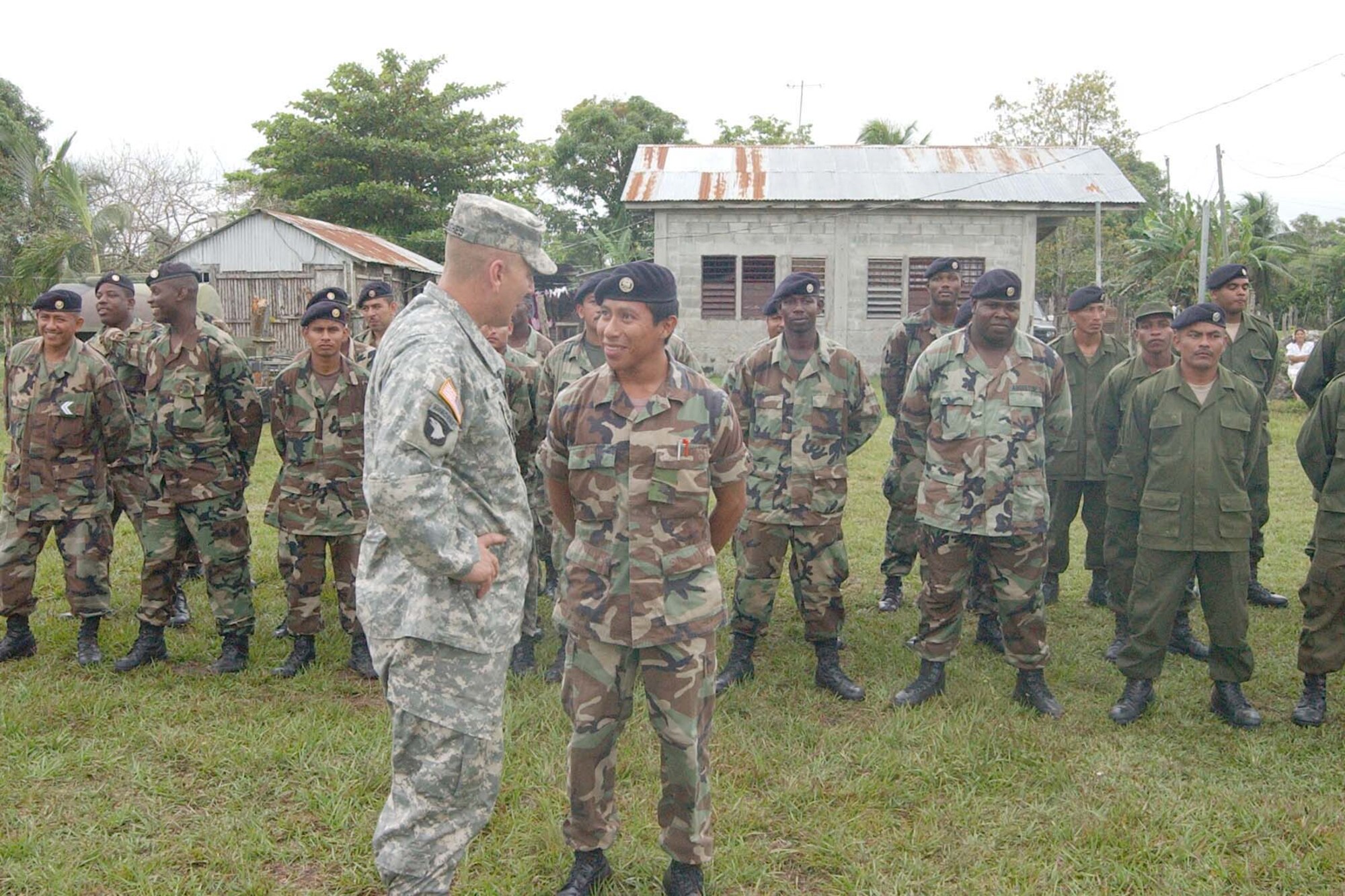 TRIAL FARM, Belize -- Army Col. Christopher Hughes, Joint Task Force-Bravo commander from Soto Cano Air Base, Honduras, talks with a member of the Belize Defense Force during the New Horizons Belize 2007 opening ceremonies. Active-duty and Guard Soldiers, Sailors and Airmen will work shoulder to shoulder with members of the Belize Defense Force during New Horizons Belize 2007.  (U.S. Air Force photo/Staff Sgt. Chyenne Griffin)
