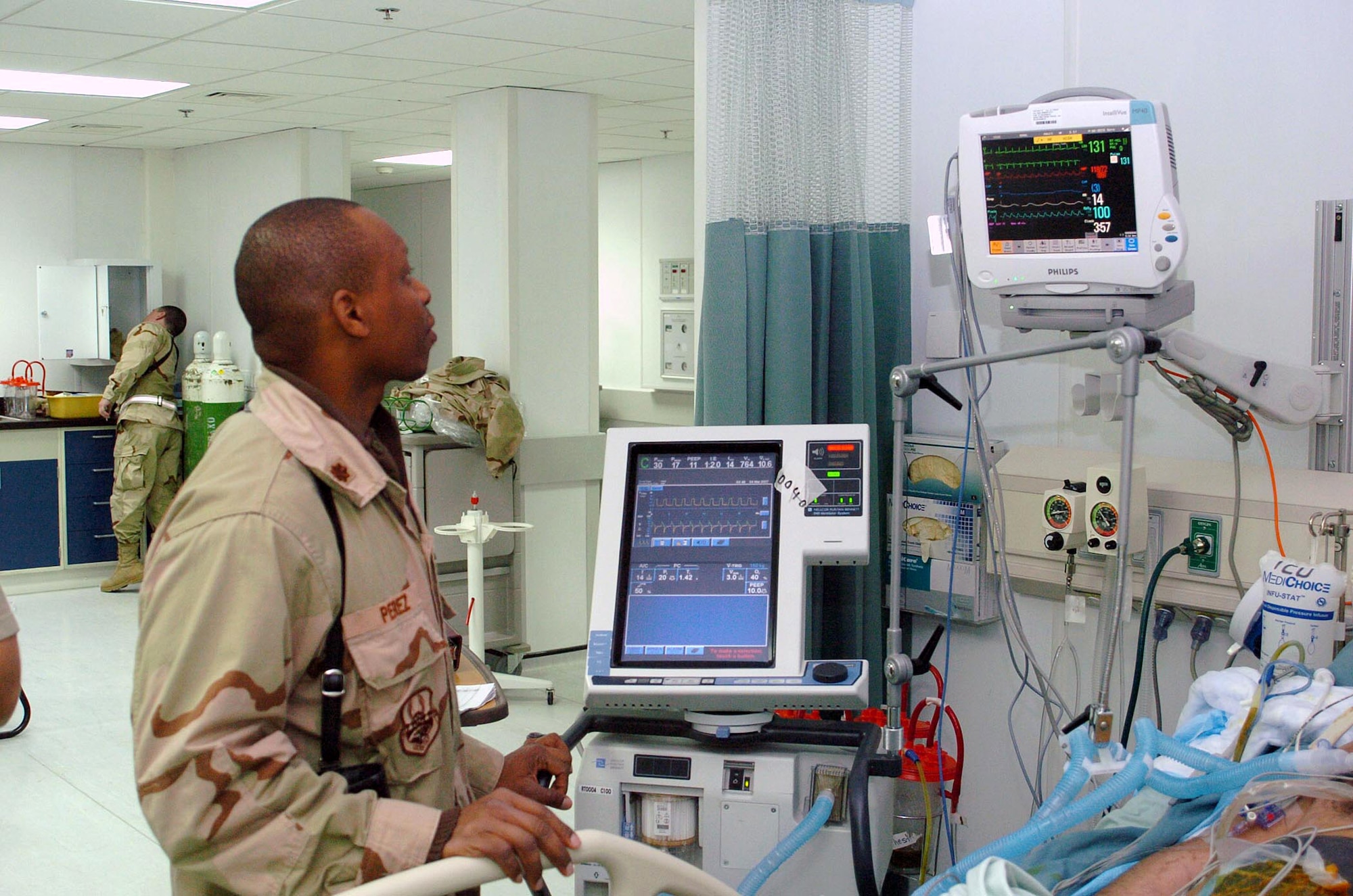 General surgeon Major (Dr.) Clifford Perez uses the new state-of-the-art vital sign monitors to check his patient's condition March 4 at the Craig Joint Theater Hospital, at Bagram Air Base, Afghanistan. The hospital features state- of-the-art technology comparable to that found in stateside hospitals. (U.S. Air Force photo/Staff Sgt. Thomas J. Doscher)
