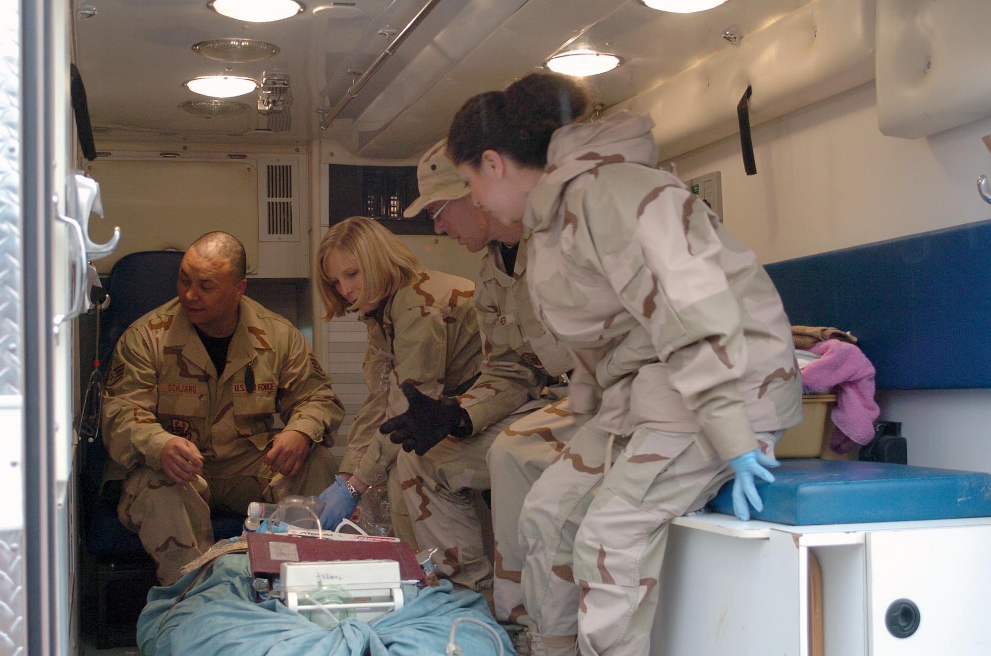 Staff Sgt. Hans Schjang, Capt. Brandy Casteel, Tech. Sgt. Daniel Fischer and Senior Airman Claudia Rodke prepare to move a patient March 4 from the old task force medical hospital to the newly opened Craig Joint-Theater Hospital at Bagram Air Base, Afghanistan. (U.S. Air Force photo/Staff Sgt. Thomas J. Doscher) 