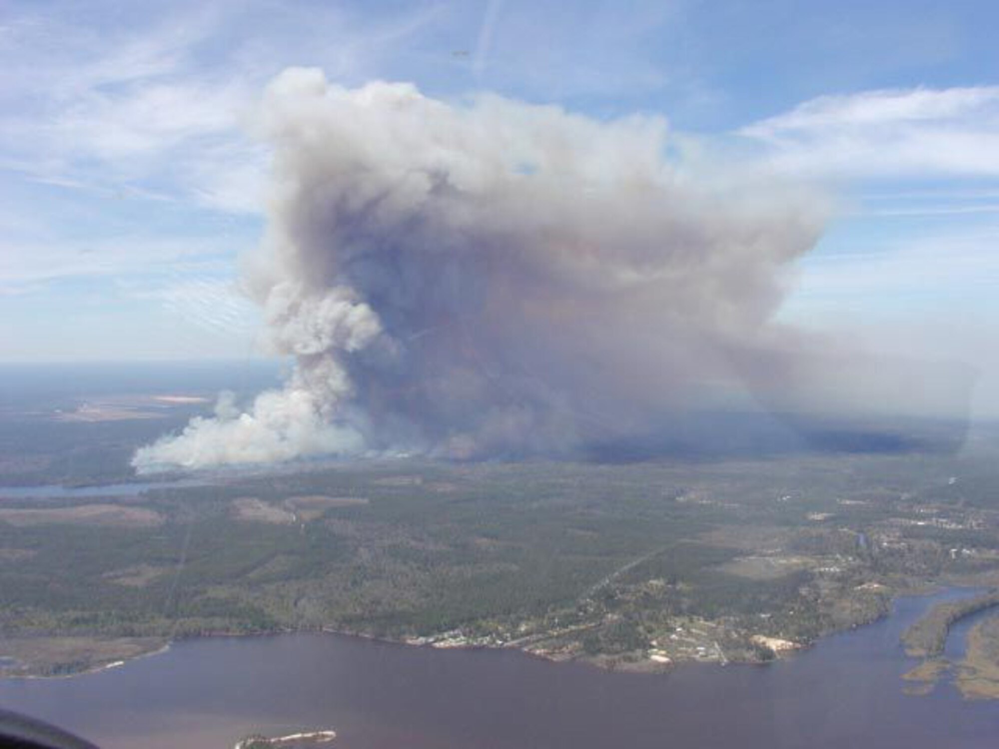 A large smoke plume rises during a prescribed burn on the Eglin reservation.  Eglin wildland fire managers use four official weather forecasts to ensure the right conditions exist to help them limit the impacts of smoke at the ground level during a prescribed burn.