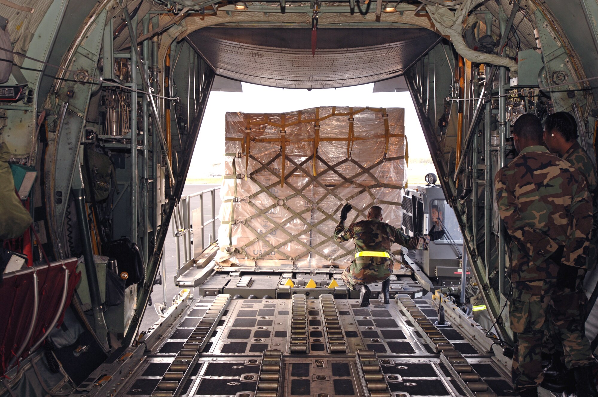 Airmen load a C-130 Hercules with humanitarian supplies March 4 at Homestead Air Reserve Base, Fla. U.S. Southern Command, in cooperation with the U.S. Agency for International Development, delivered the supplies in response to devastating floods in eastern Bolivia. (U.S. Army photo/Spc. Clayton Corey)
