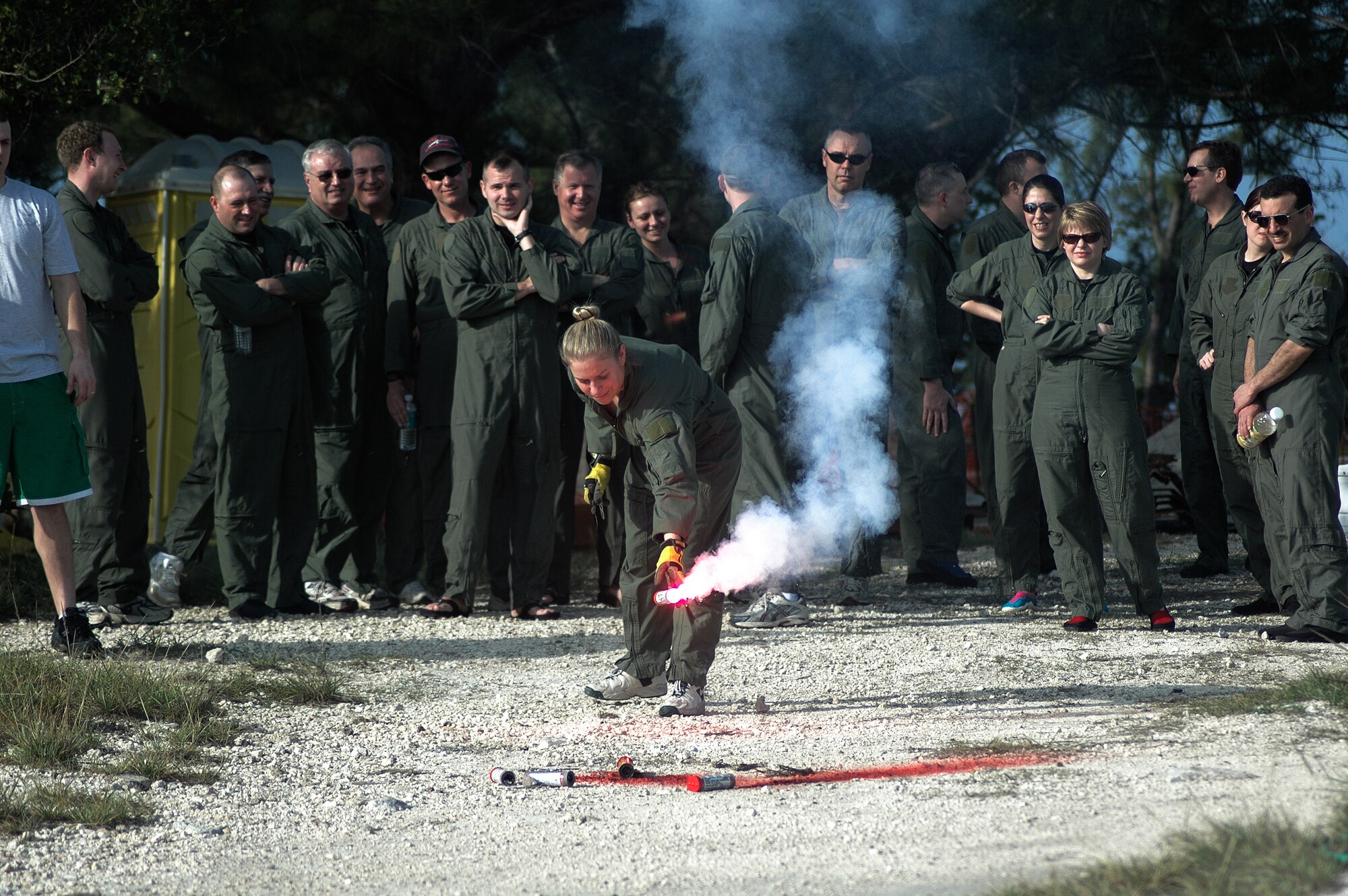 Aircrew surivival training teaches flyers how to survive in hostile and unforgiving environments. Tech. Sgt. Ava Swedock, a 337th Airlift Squadron loadmaster, practices lighting a rescue flare during the exercise at a beach in Key West, Fla. 