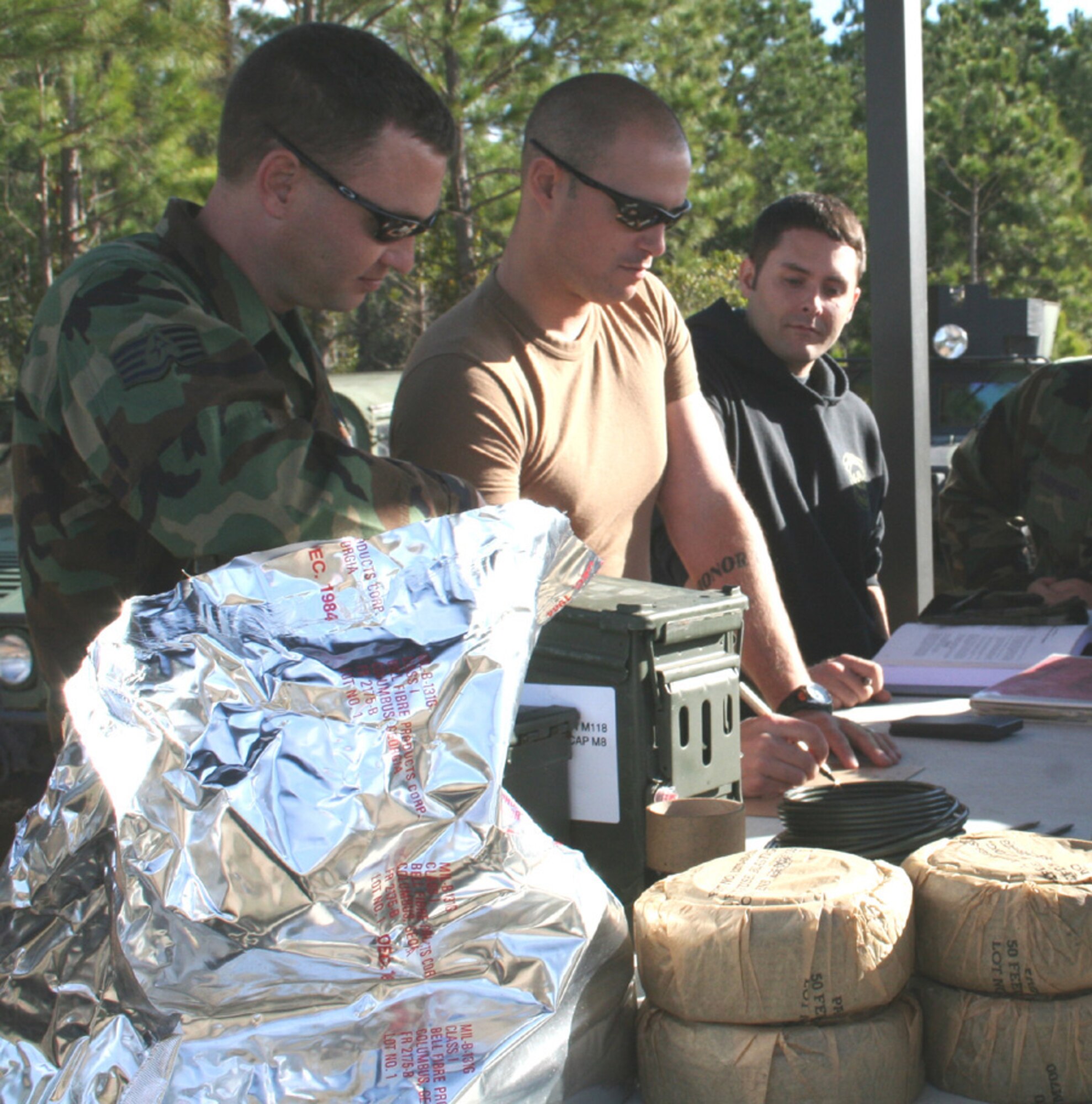 EOD Airmen go over procedures before starting a training session at the range. (U.S. Air Force photo by Staff Sgt. Angela Shepherd)