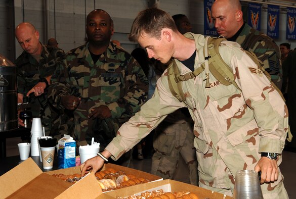 Airmen help themselves to snacks after returning home from deployments to Southwest Asia Wednesday. (Courtesy photo)