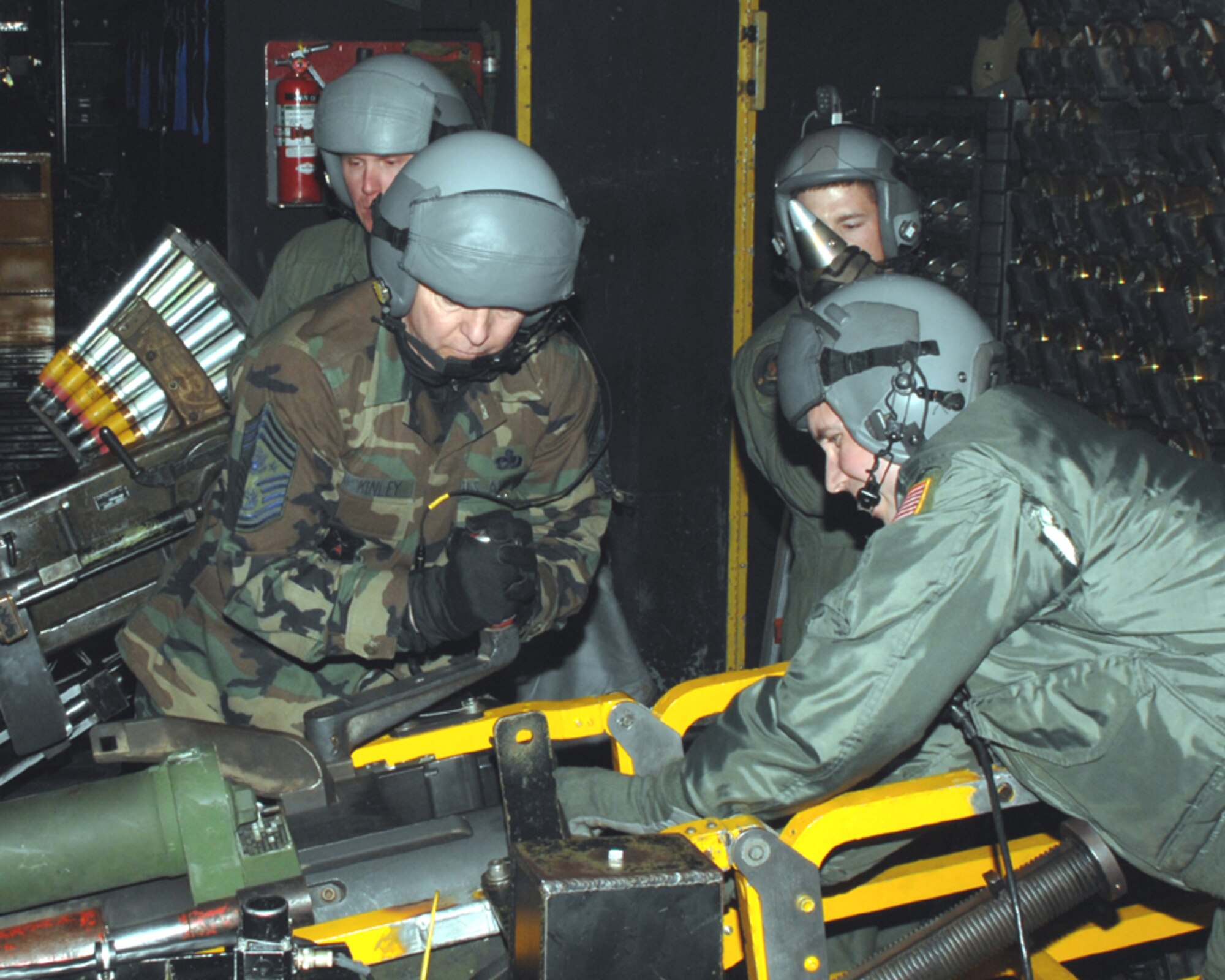 Chief Master Sgt. of the Air Force Rodney J. McKinley joins a 16th Special Operations Squadron gunner, Master Sgt. Preface Hedin, with loading the 105mm howitzer on the AC-130H Spectre gunship Monday night, while Senior Airman Mathew Busman works the 40mm Bofors cannon, and Staff Sgt. James Mobley oversees the process. The chief visited Hurlburt Monday and Tuesday. (U.S. Air Force photo by Senior Airman Andy Kin)