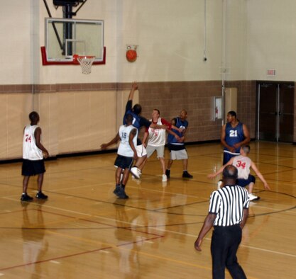 Members of the 82nd Civil Engineer Squadron and the Delta 264th Medical Battalion get ready to try and grab a rebound during the intramural basketball championships March 5 at the Levitow Fitness Center. The 82nd CES won, 52-50. (U.S. Air Force photo/Airman 1st Class Jacob Corbin)