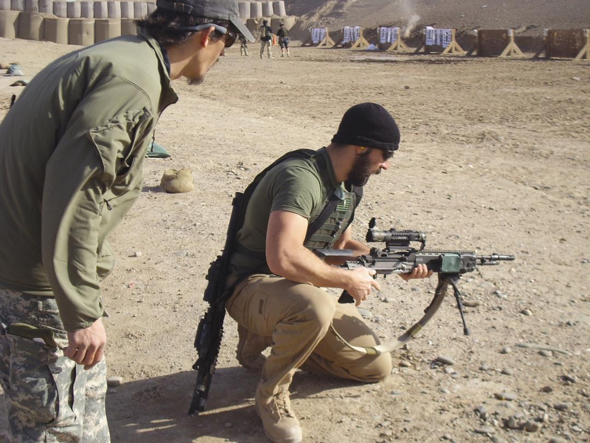 Senior Master Sgt. Timothy Lum (left) and Senior Airman Brian Kimber, both 306th Rescue Squadron pararescuemen, sharpen their shooting skills at the range during down time Feb. 28. (U.S. Air Force photo/Senior Airman Andrea Wright)