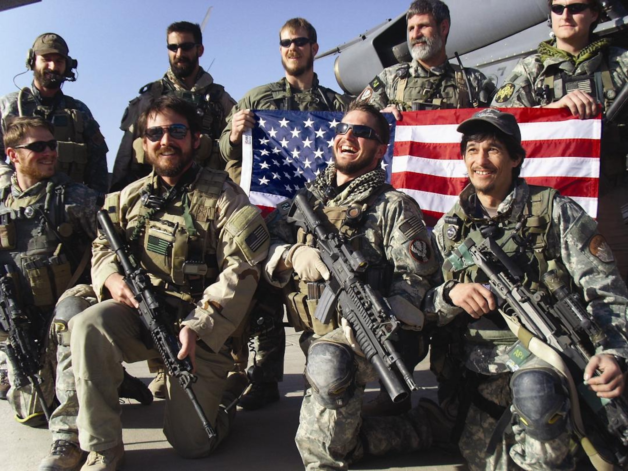Airmen from the 306th Rescue Squadron from Tucson, Ariz., pose for a group picture outside Kandahar Airfield, Afghanistan. The Airmen have relaxed grooming standards since they are in close contact with the Afghan population. (U.S. Air Force photo/Senior Airman Andrea Wright)