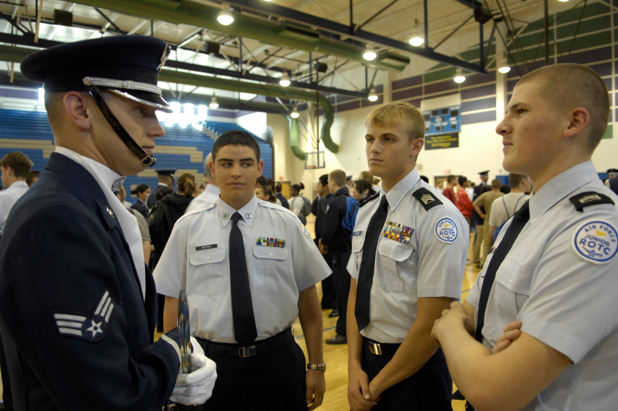 Senior Airman James Floyd talks with students from the Las Vegas area about the United States Air Force at Canyon Springs High School, Las Vegas, Nev., March 8, 2007. The Drill Team is the traveling component of the Air Force Honor Guard and tours Air Force bases world wide showcasing the precision of today's Air Force to recruit, retain, and inspire Airmen for the Air Force mission. (U.S. Air Force photo by Airman 1st Class Rusti Caraker)(Released)