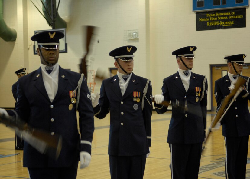 The United States Air Force Honor Guard Drill Team members perform one of their trademark manuevers, the line sequence for students at Canyon Springs High School, Las Vegas, Nev., March 8, 2007. The Drill Team is the traveling component of the Air Force Honor Guard and tours Air Force bases world wide showcasing the precision of today's Air Force to recruit, retain, and inspire Airmen for the Air Force mission. (U.S. Air Force photo by Airman 1st Class Rusti Caraker)(Released)