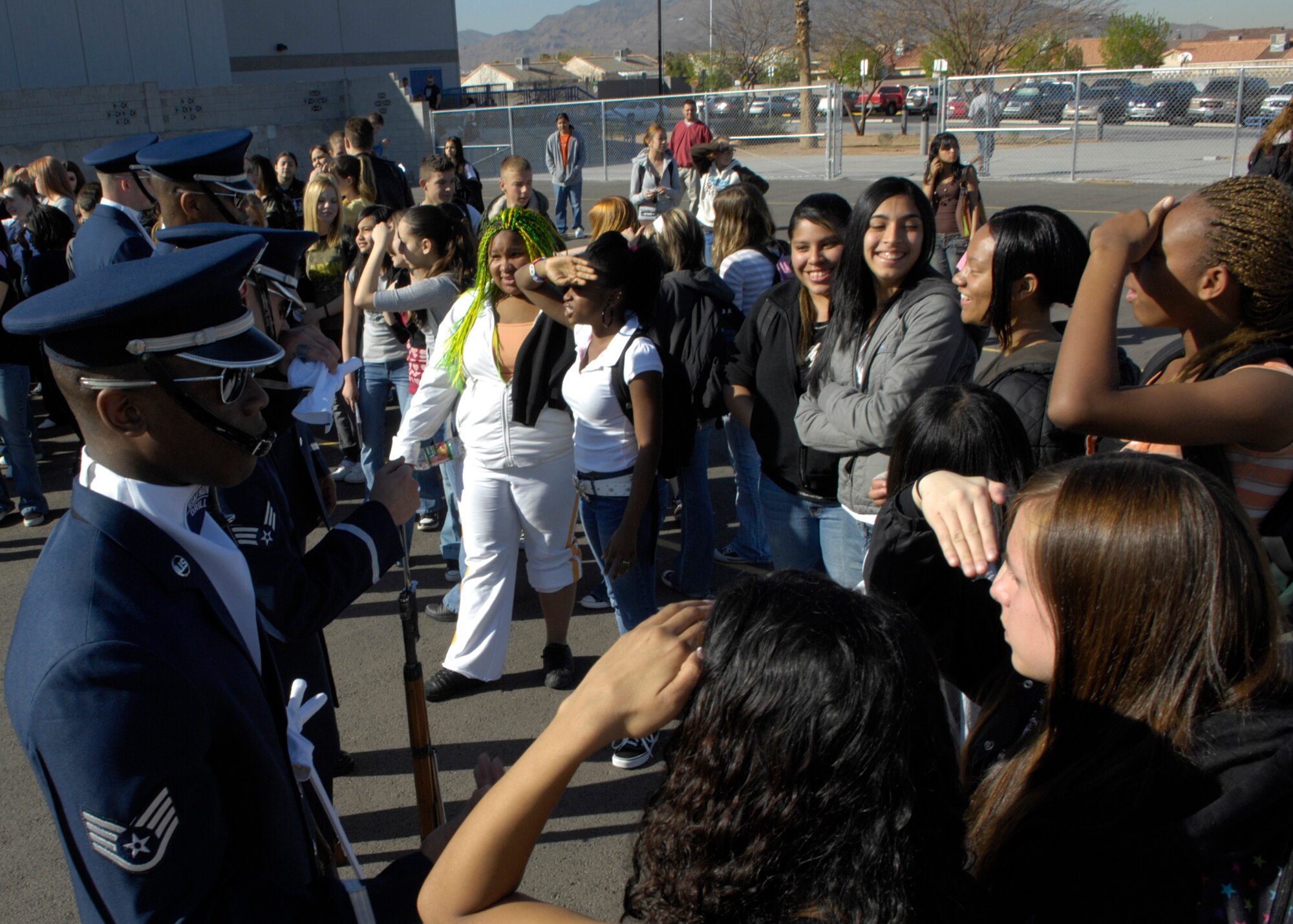 Staff Sgt Theodore Miller and other United States Air Force Honor Guard Drill Team members talk with students of Basic High School after performing for the Desert Tour, Las Vegas, Nev., March 8, 2007. The Drill Team is the traveling component of the Air Force Honor Guard and tours Air Force bases world wide showcasing the precision of today's Air Force to recruit, retain, and inspire Airmen for the Air Force mission. (U.S. Air Force photo by Airman 1st Class Rusti Caraker)(Released)