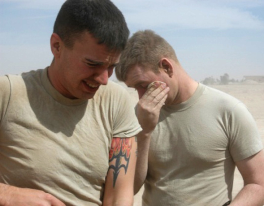 Army Spc. David Geisman (left) and Spc. Chad Dunford do their best to shield themselves from blowing sand during a March 5 windstorm at Besimaya Range Complex in Iraq. The soldiers are assigned to both of Company A, 1/115th Field Artillery, 867th Corps Support Battalion, 15th Sustainment Brigade. Photo by Sgt. 1st Class Nicholas Conner, USA