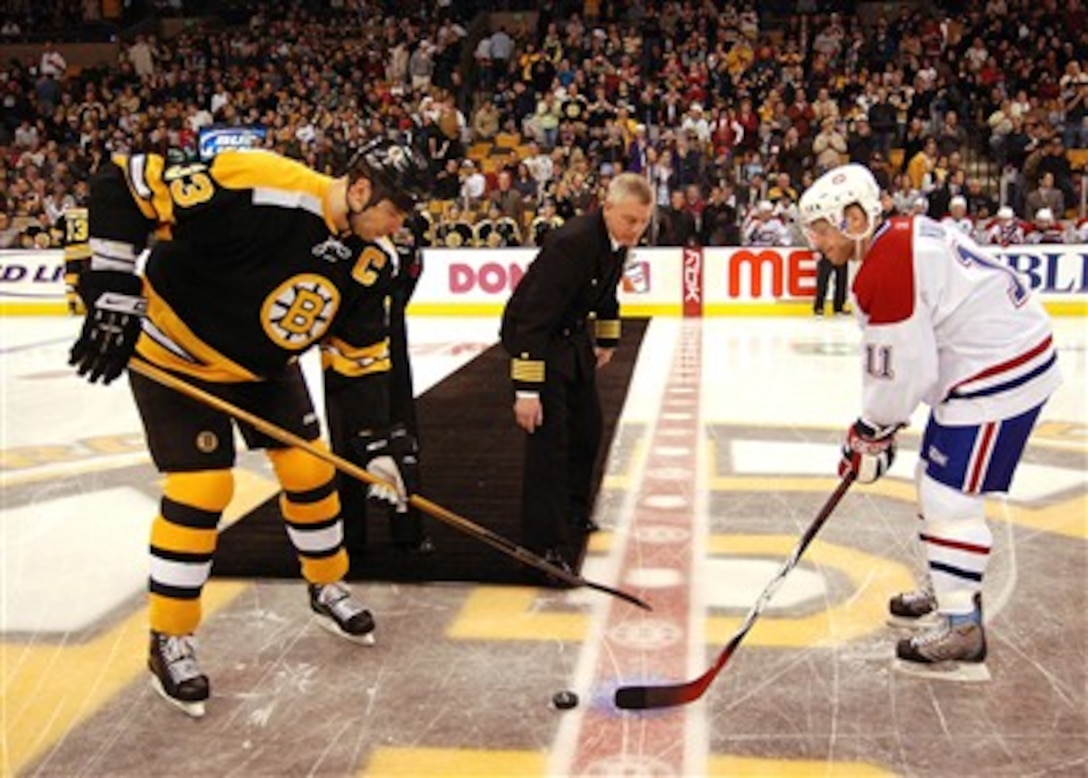 U.S. Navy Capt. Todd A. Zecchin, commanding officer of USS John F. Kennedy, drops the ceremonial puck at the Boston Bruins and Montreal Canadians game at the TD Banknorth Garden in Boston, Mass., March 3, 2007. John F. Kennedy is in Boston for a five-day port visit prior to its March 23 decommissioning in Mayport, Fla.