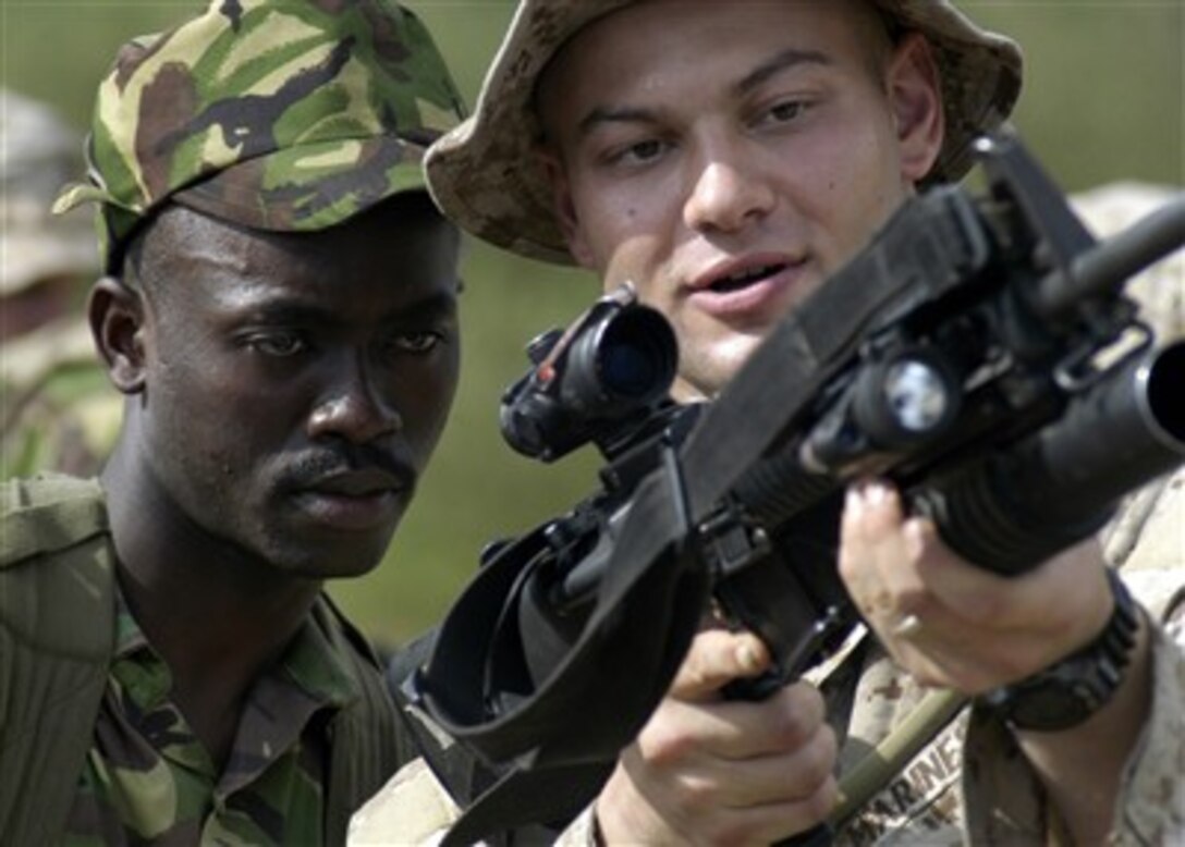 U.S. Marine Corps Cpl. Dustin Crouthamel (right) familiarizes a member of the Kenyan army with his rifle as part of bilateral exercise Edged Mallet '07 in Manda Bay, Kenya, on March 4, 2007.  Crouthamel is assigned to Fox Company, Battalion Landing Team 2/2, 26th Marine Expeditionary Unit.  The 26th Marine Expeditionary Unit is conducting the bilateral exercise including operational training with Kenyan land and naval forces as well as serving the local community at a medical clinic and refurbishing a school.  