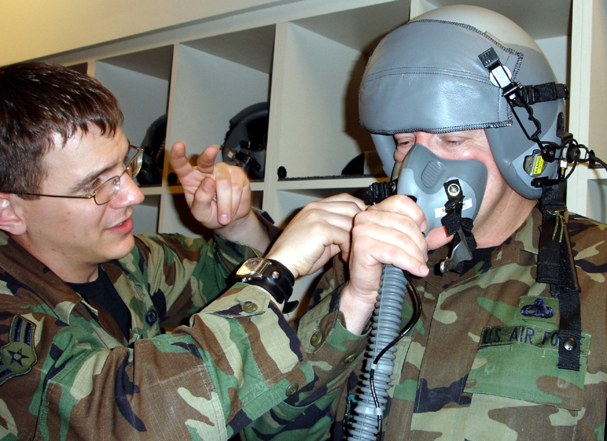 Airman 1st Class Mathew Shultz, 16th Special Operations Squadron, fits Chief Master Sgt. of the Air Force Rodney J. McKinley with life support gear prior to his orientation flight at Hurlburt Field March 5. (U.S. Air Force photo/Tech. Sgt. Michael Coffey)