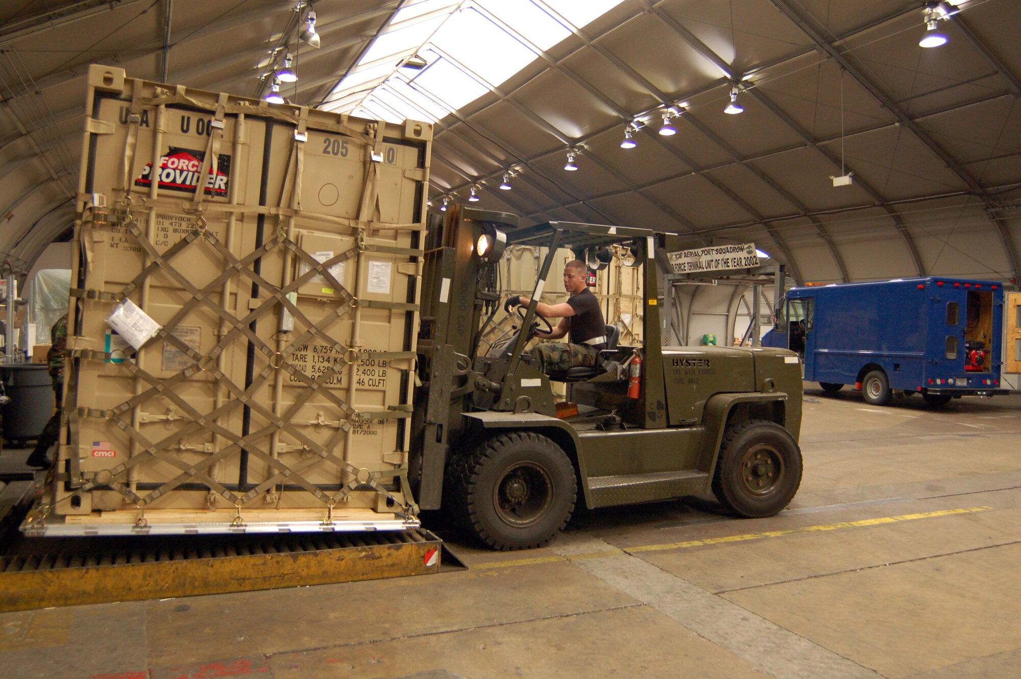 DOVER AIR FORCE BASE, Del. -- Airman Basic Chet Collins, 436th Aerial Port Squadron Ramp and Cargo specialist, moves a 'City in a Box' Force Provider for shipment on an Air Force C-17 to a deployed location Feb. 23. (U.S. Air Force photo/Tech. Sgt. Kevin Wallace)