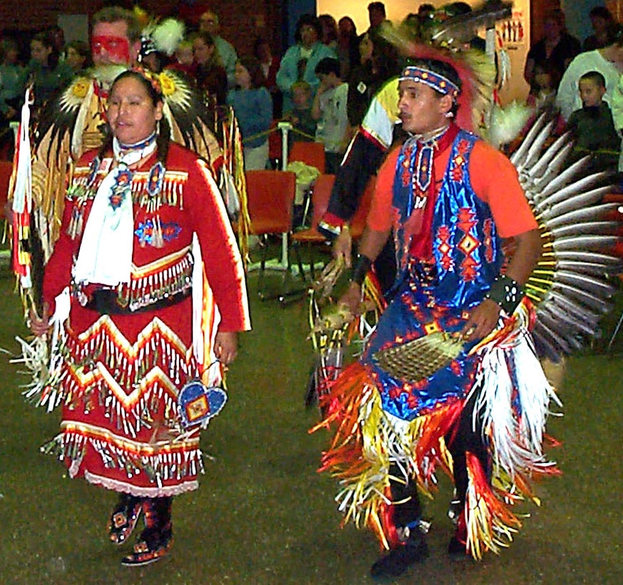 Justine Reed, left, dances around the ceremonial area with an unidentified male dancer during the American Indian Intertribal Cultural Organization Second Annual Veterans Powwow celebration, held at Central Middle School in Edgewater, Md., Nov. 8. Photo by Rudi Williams