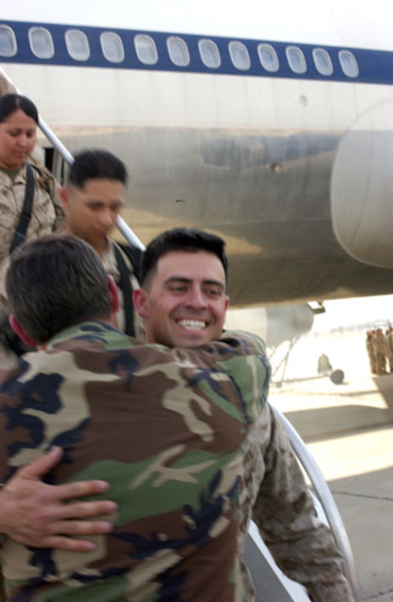 Cpl. Gabriel Bullard hugs his dad, Maj. James Bullard, after returning from Iraq.  The two were reunited at March Air Reserve Base.  (U.S. Air Force photo by Staff Sgt. Amy Abbott)