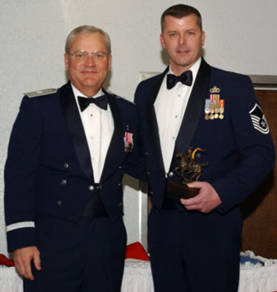 Brig. Gen. James L. Melin, 452nd AMW commander, presents the Senior NCO of the Year award to Master Sgt. William Wieber, 452 SFS.  The 452d Air Mobility Wing's 13th Annual Awards Banquet recognized the men and women in the wing who have made a difference in 2006.  The banquet was held at March Air Reserve Base in February.  (U.S. Air Force photo by 4th Combat Camera)
