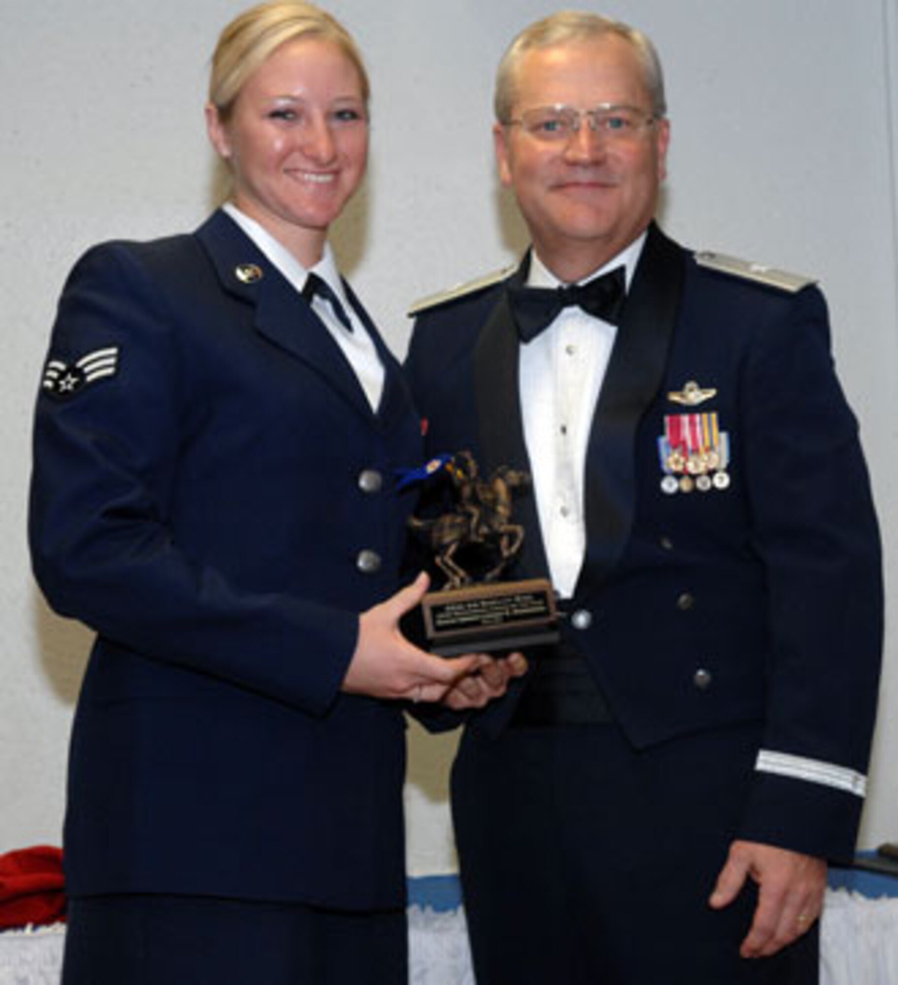 Brig. Gen. James L. Melin, 452nd AMW commander, presents the Airman of the Year award to Senior Amn. Lyndsey Wisniewski, 452 AES. The 452d Air Mobility Wing's 13th Annual Awards Banquet recognized the men and women in the wing who have made a difference in 2006.   The banquet was held at March Air Reserve Base in February. (U.S. Air Force photos by 4th Combat Camera)