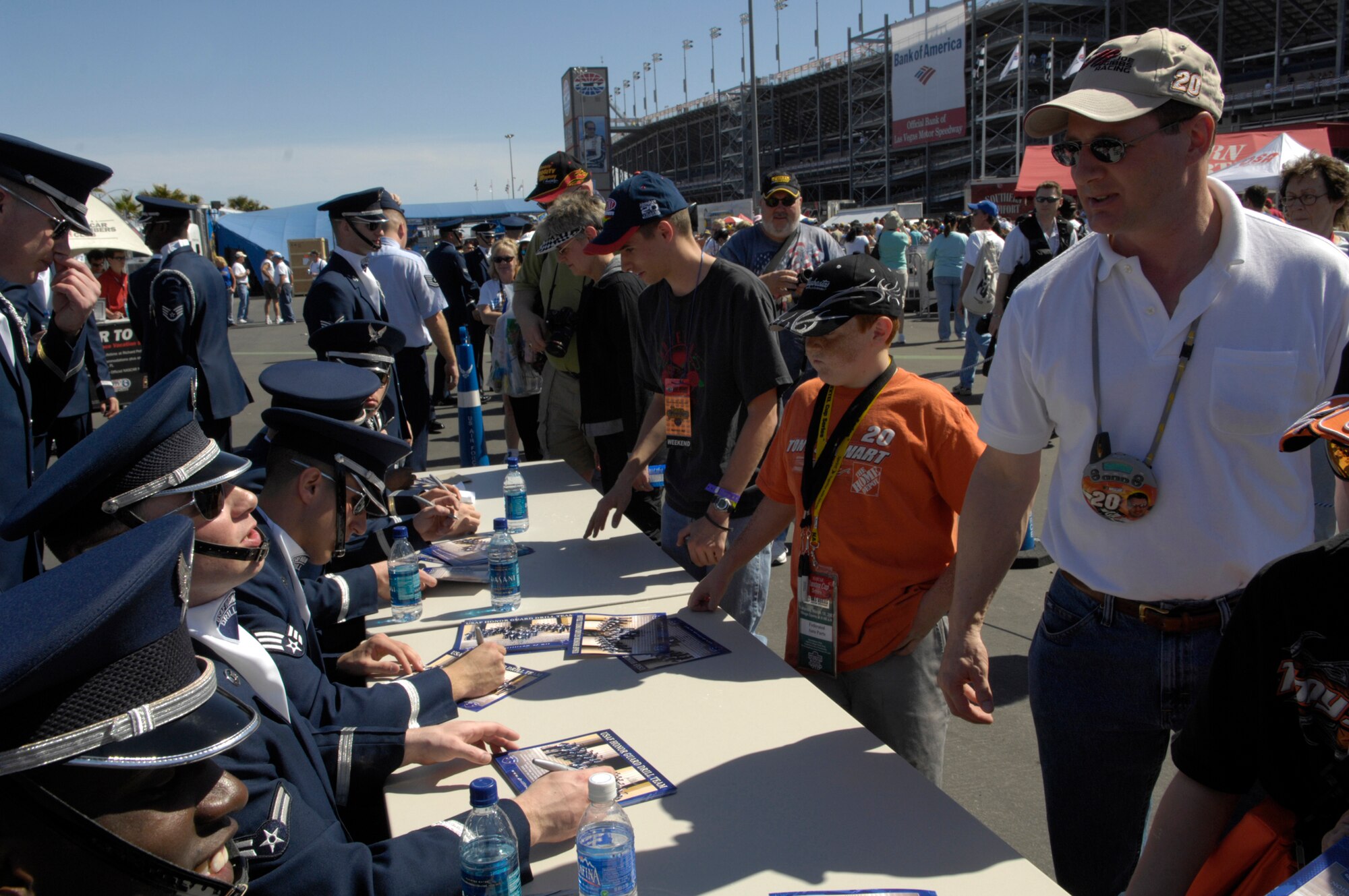 The United States Air Force Honor Guard Drill Team autographs AF recruiting posters after their performance at the Las Vegas Motor Speedway, Las Vegas, Nev., March 10, 2007. The Drill Team is the traveling component of the Air Force Honor Guard and tours Air Force bases world wide showcasing the precision of today's Air Force to recruit, retain, and inspire Airmen for the Air Force mission. (U.S. Air Force photo/Airman 1st Class Rusti Caraker)