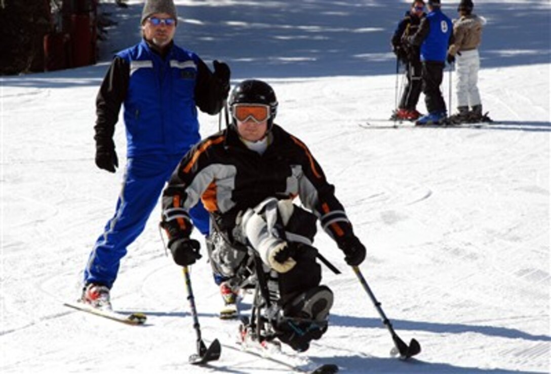 Sgt. Anthony Larson, his adaptive ski instructor close behind, skis down the beginner’s hill on his mono-ski March 9 in Vail, Colo. Larson lost his right leg below the knee while serving in Iraq. The lesson is part of the Vail Veterans Program’s winter sports clinic. 